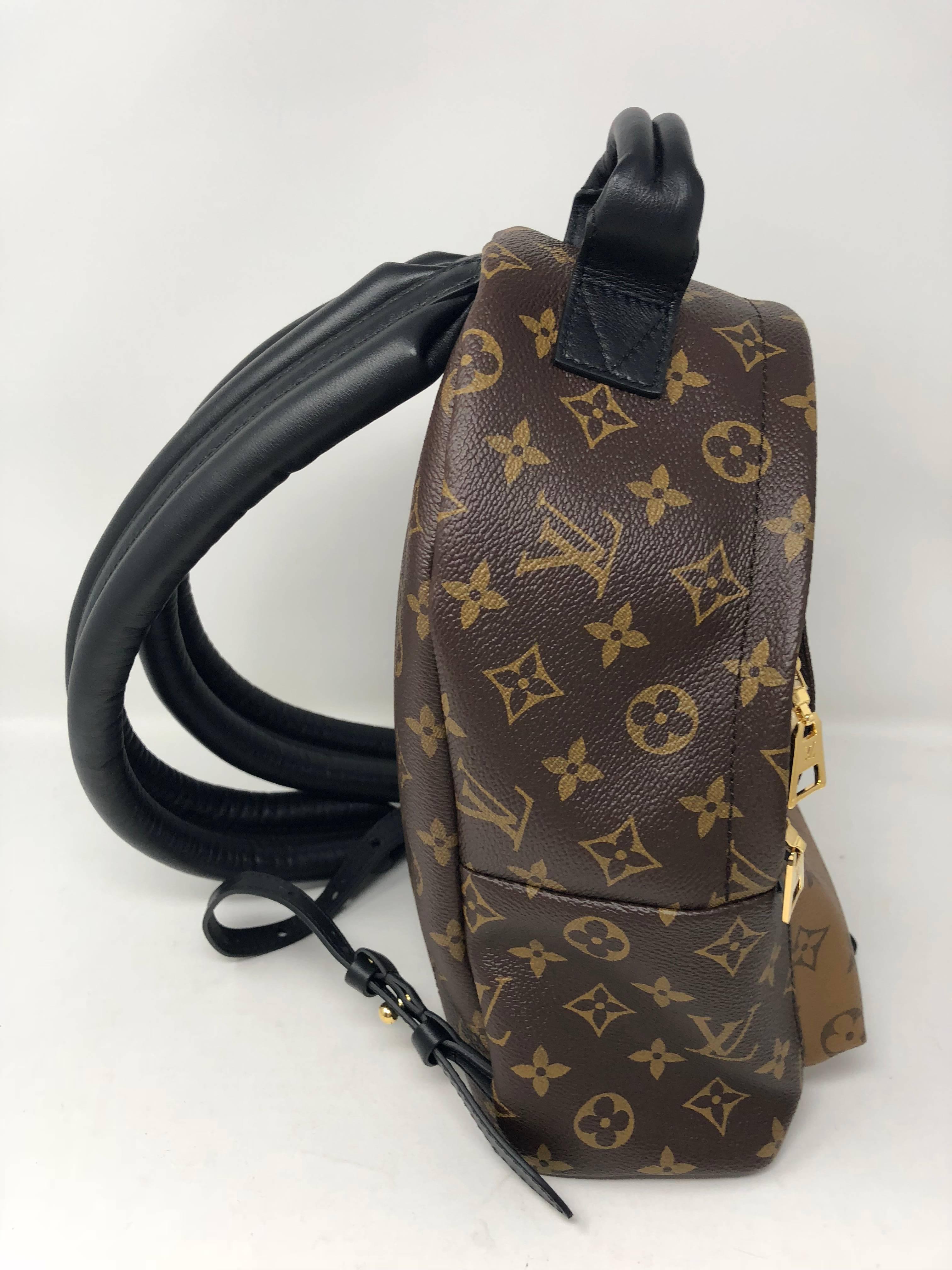 Louis Vuitton Reverse Palm Springs Backpack PM in new condition. The back pack handles are made of a strong black cowhide and are wide for easy comfort. They are also adjustable for any height. Unique reverse monogram covers the front pocket and the