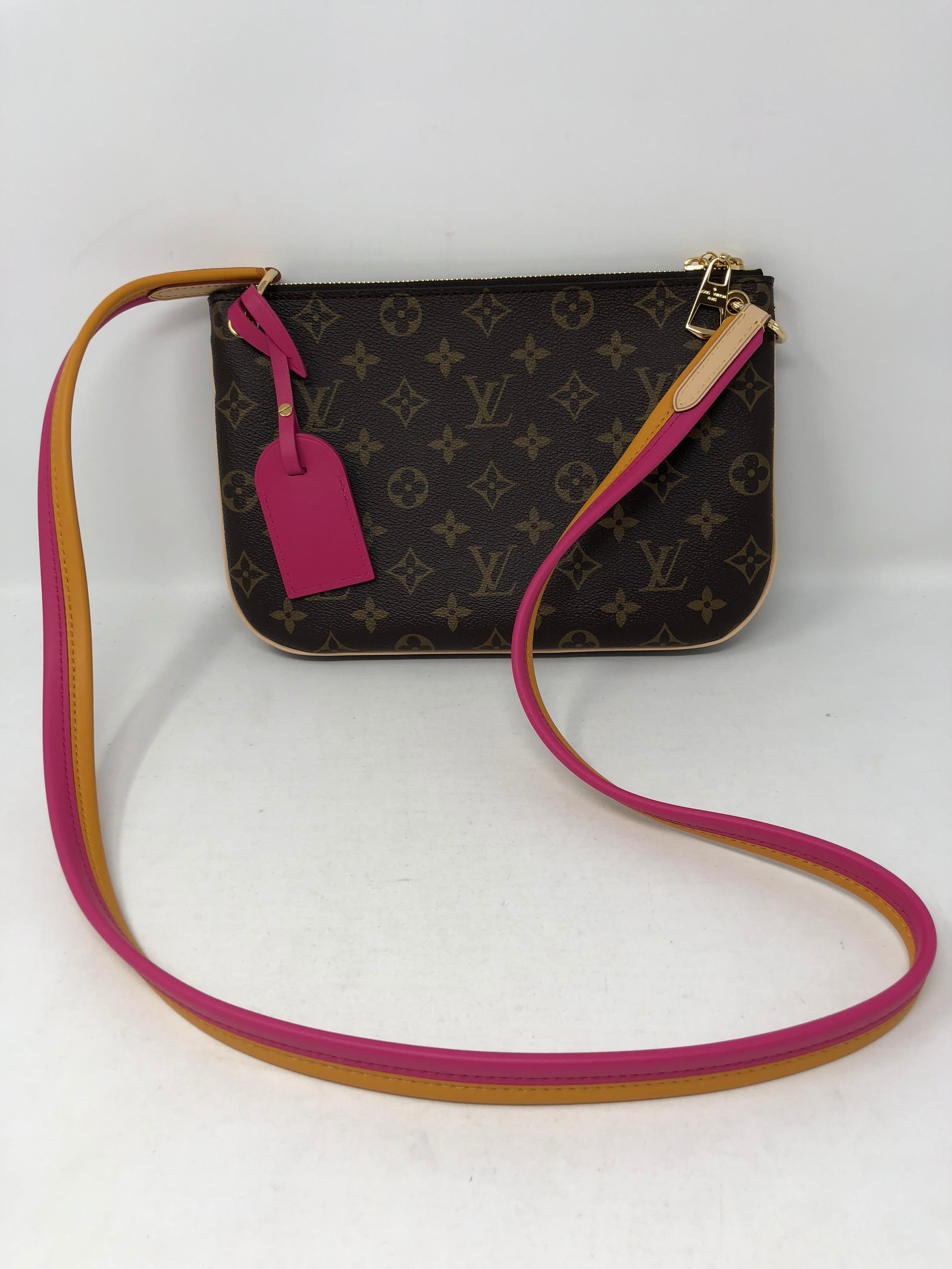 Louis Vuitton with pink and orange leather strap crossbody bag. Brand new and never used. Guaranteed authentic. 