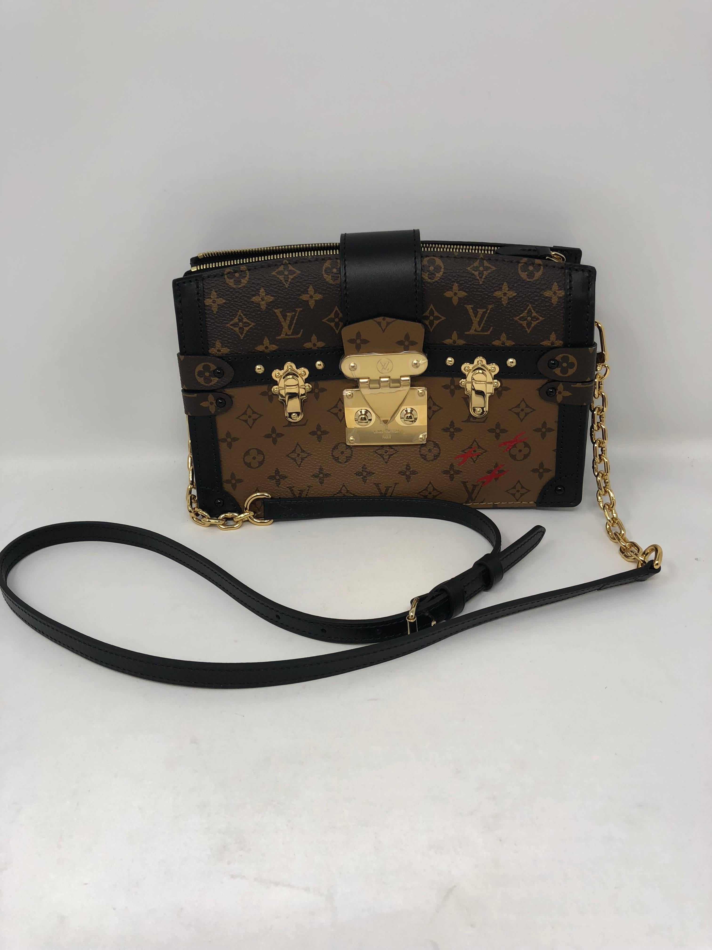 Limited edition Louis Vuitton Clutch and crossbody from Runway Collection Fall 2018. Special trunk collection in reverse monogram. The bag features the S-lock clasp and sheepskin interior leather with Malletage print. Highly coveted and brand new