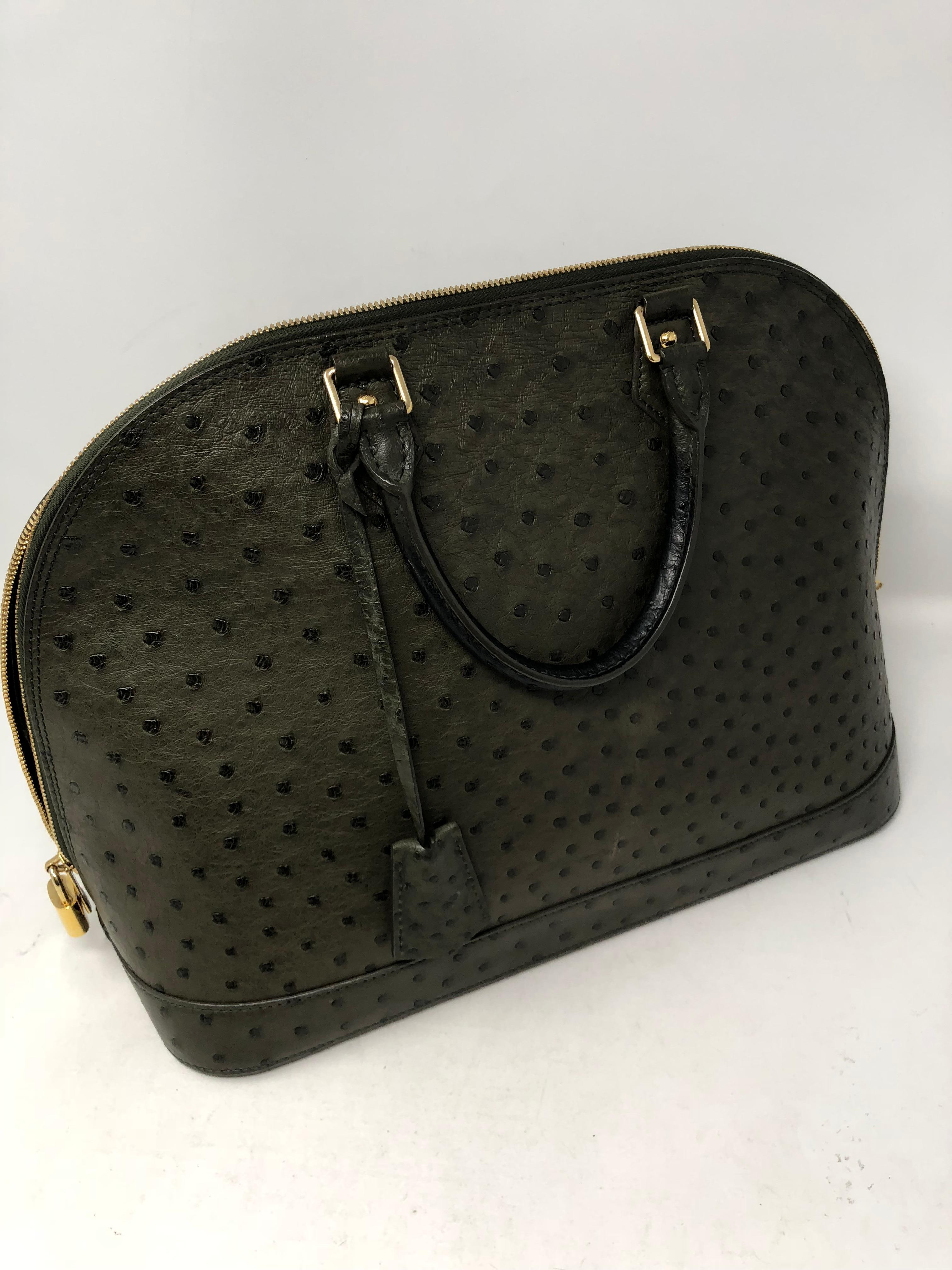 Louis Vuitton Ostrich Leather Alma Bag GM size. Rare and beautiful top handle bag in stunning gris ostrich. Great condition. Celebrity owned. Guaranteed authentic.