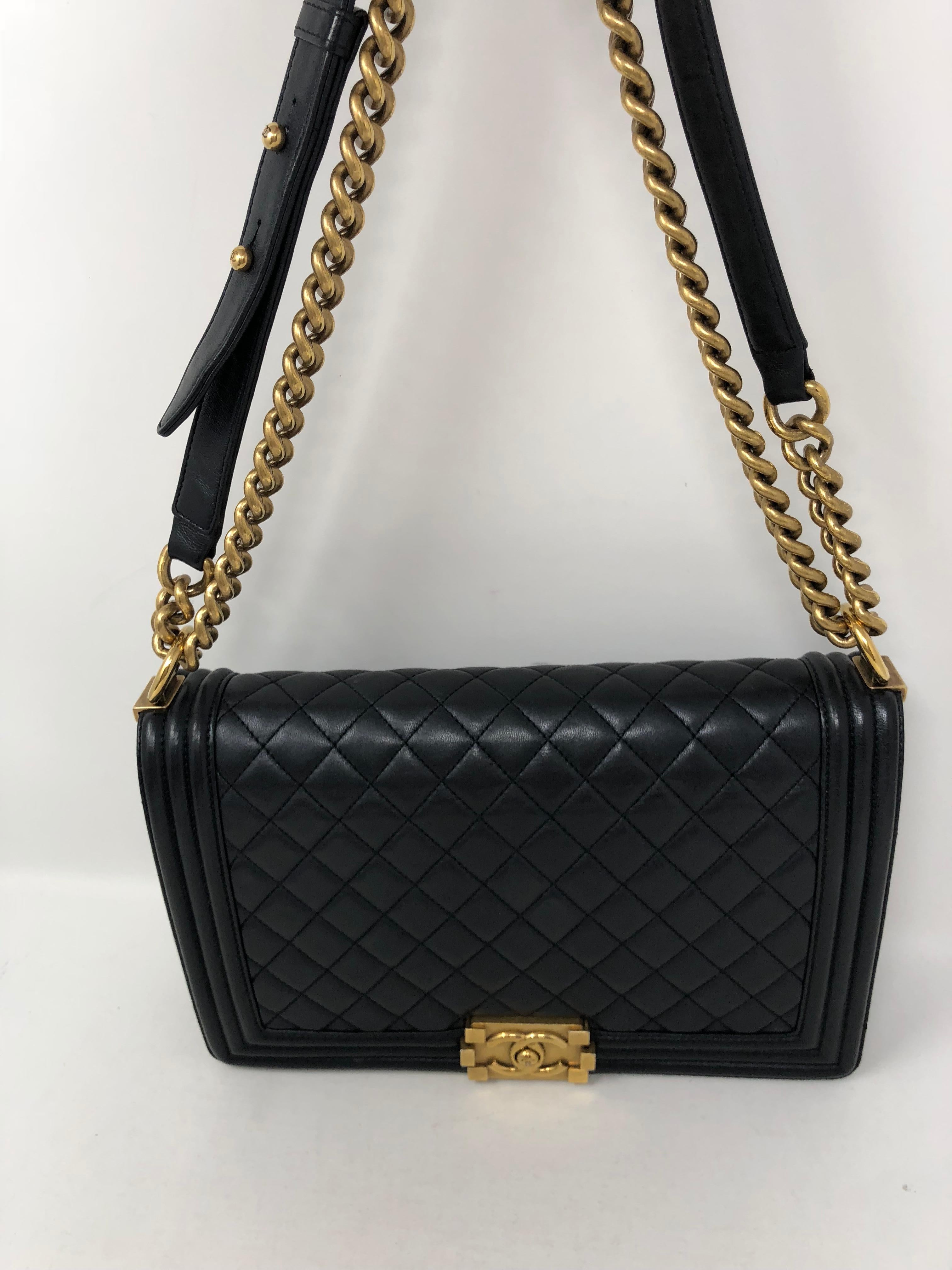 Chanel Black Boy Bag Gold Hardware. Can be worn crossbody or doubled. Black lambskin leather in good condition. Old medium size. Guaranteed authentic. 