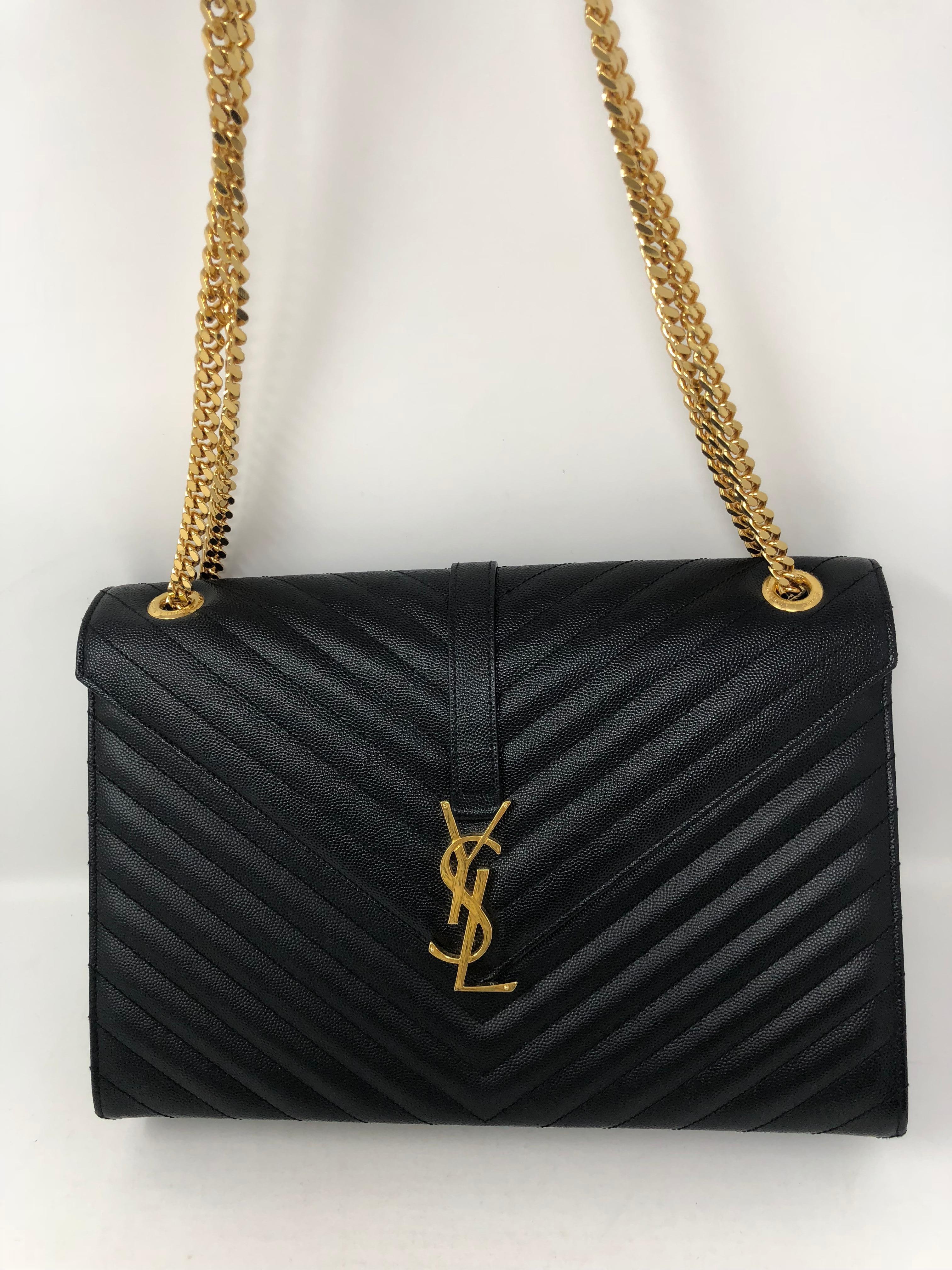 Black YSL Bag with gold hardware. Like new condition. Worn once. Shiny gold hardware in mint condition. Can be worn longer or doubled strap. Guaranteed authentic.