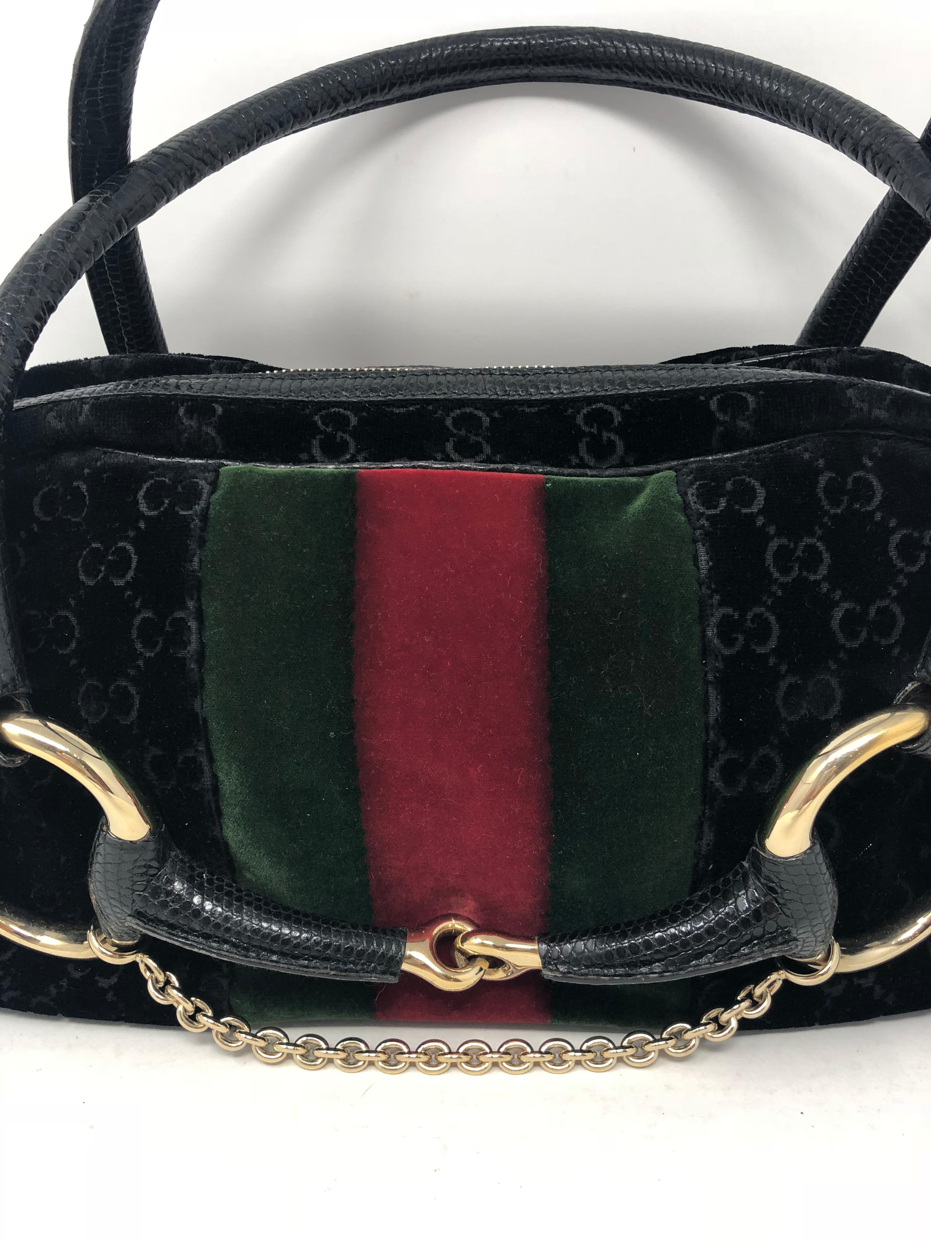 Gucci Limited Edition Black with red and green stripe. Gold horsebit and chain detail. Unique Gucci bag. Celebrity owned. Good condition. Guaranteed authentic. 