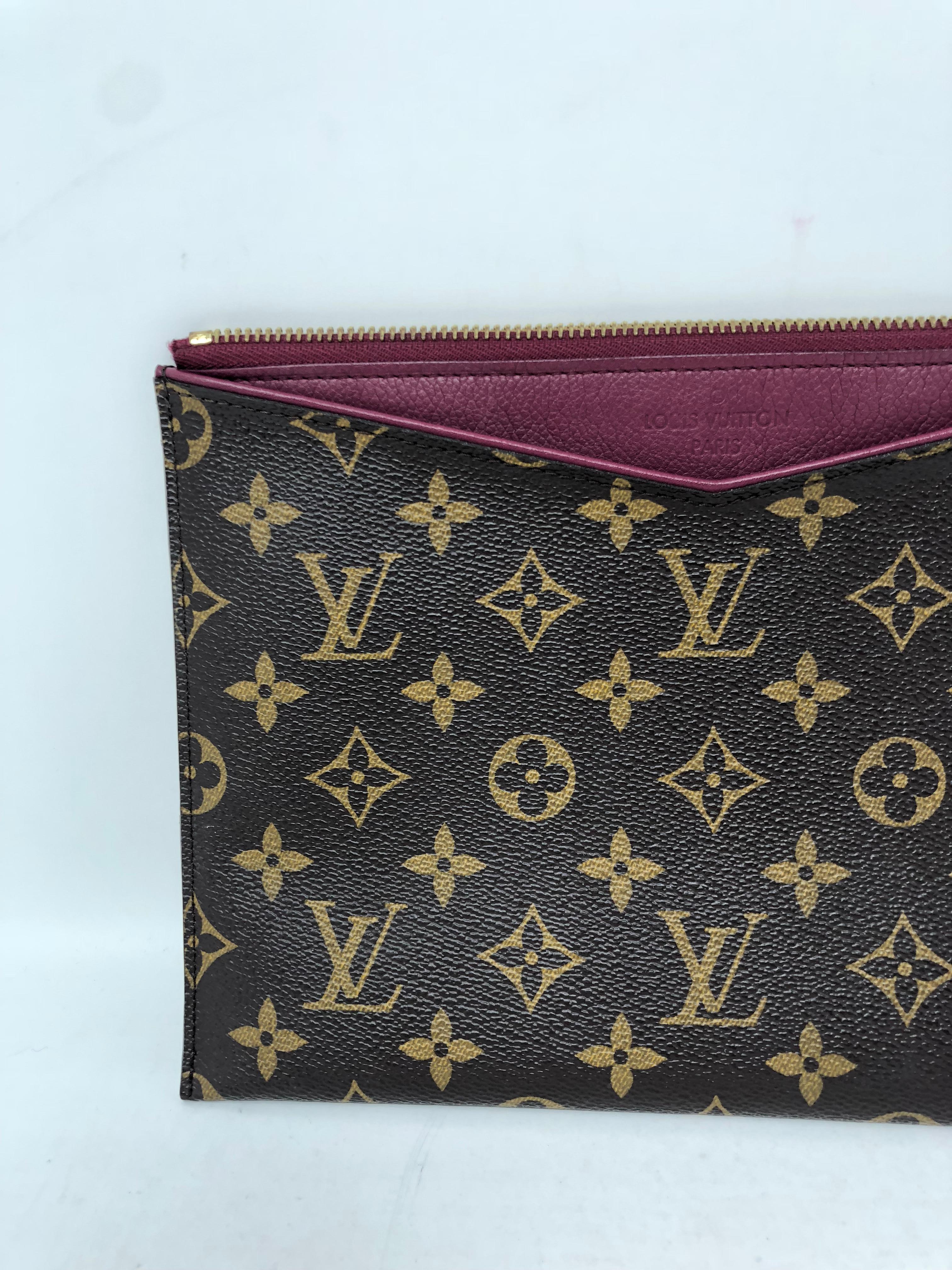 Louis Vuitton Pallas Clutch with purple interior. Retired item from LV. No longer available at Louis. It is a rare style that can be worn as a wristlet or a clutch. Monogram and leather interior with wallet inserts inside the clutch. Guaranteed