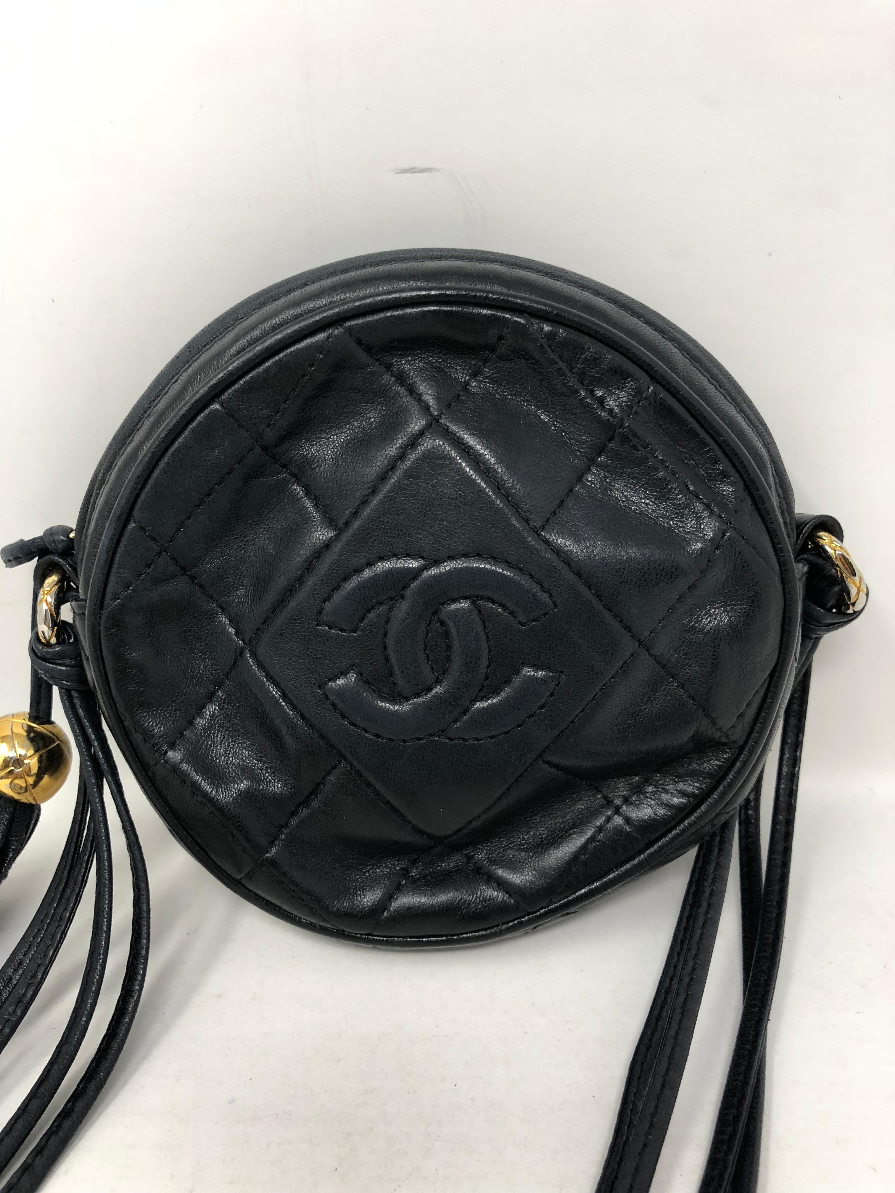 Vintage Chanel Black Chanel Crossbody with tassel. Mini circular bag that can be adjusted on strap. Matelasse Chanel lambskin with gold hardware. Cutest style by Chanel. Guaranteed authentic. 