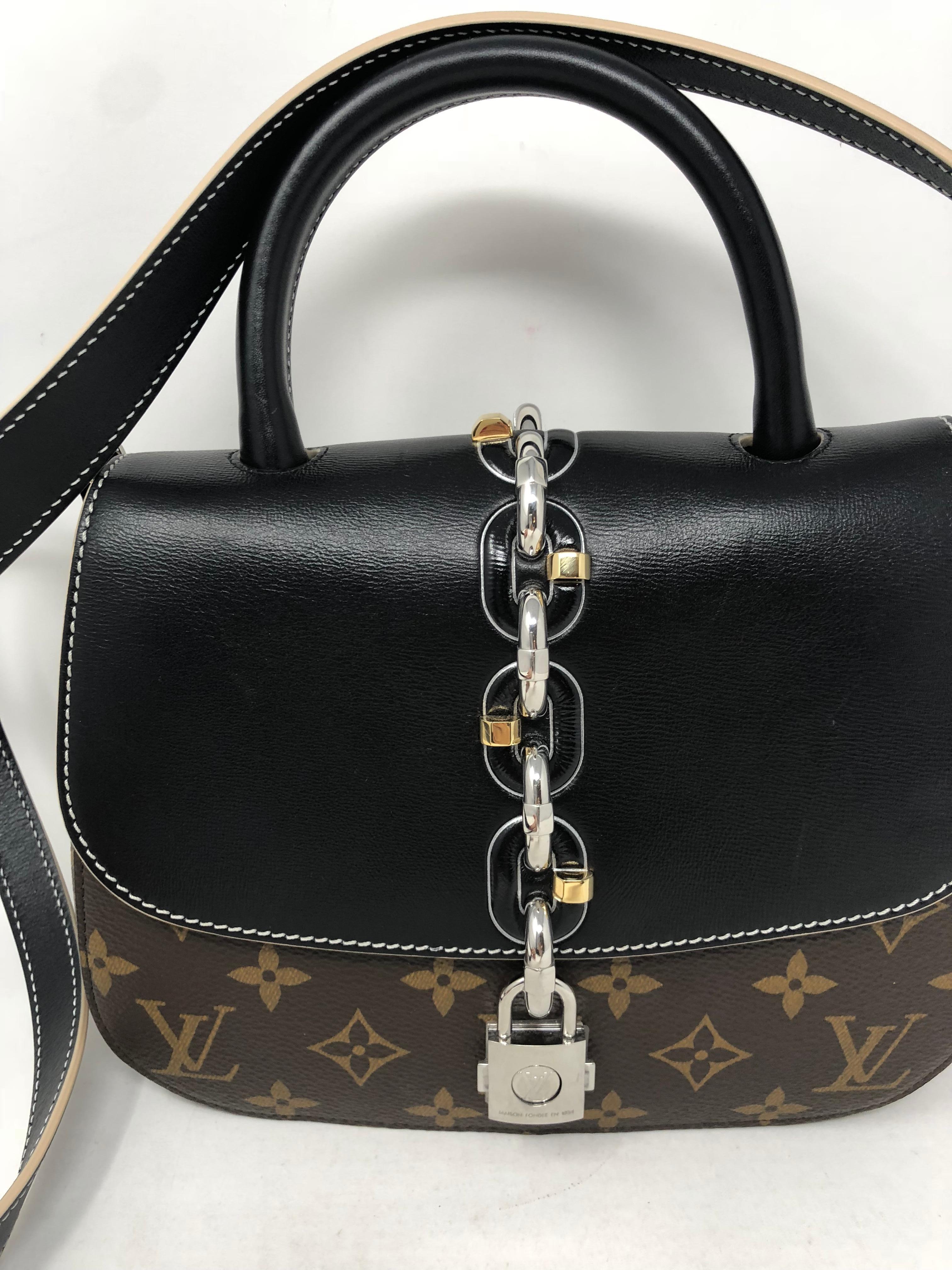 Louis Vuitton Chain It Bag in monogram and black leather. Sold out and limited. Runway piece. Like new condition. Unique closure. Guaranteed authentic. 