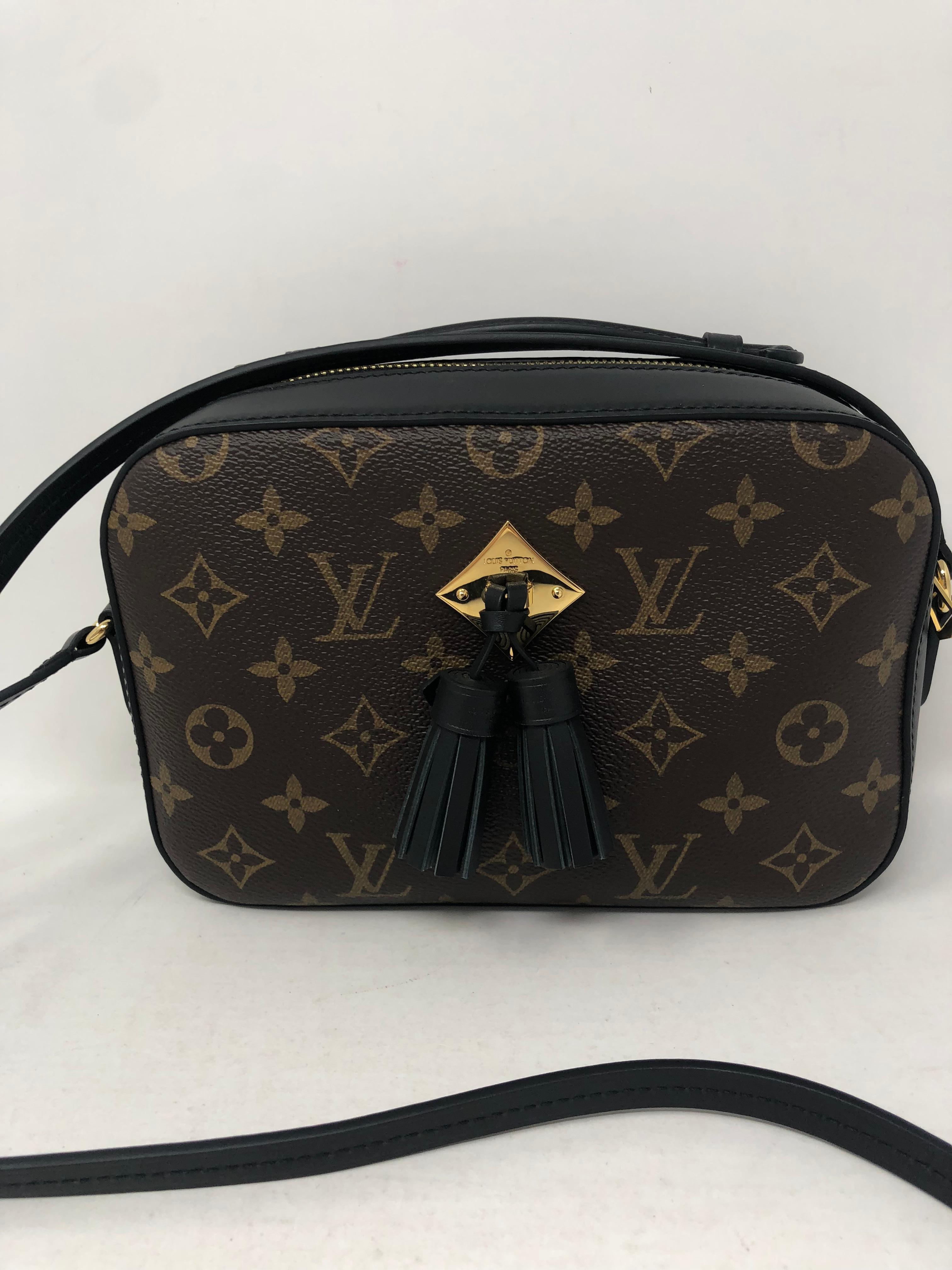 Louis Vuitton Saintonge with black leather trim. Tassel detail in front makes this a very unique bag. Gorgeous style and new condition. Sold out and not available at LV. Don't miss out on this one. Guaranteed authentic. 