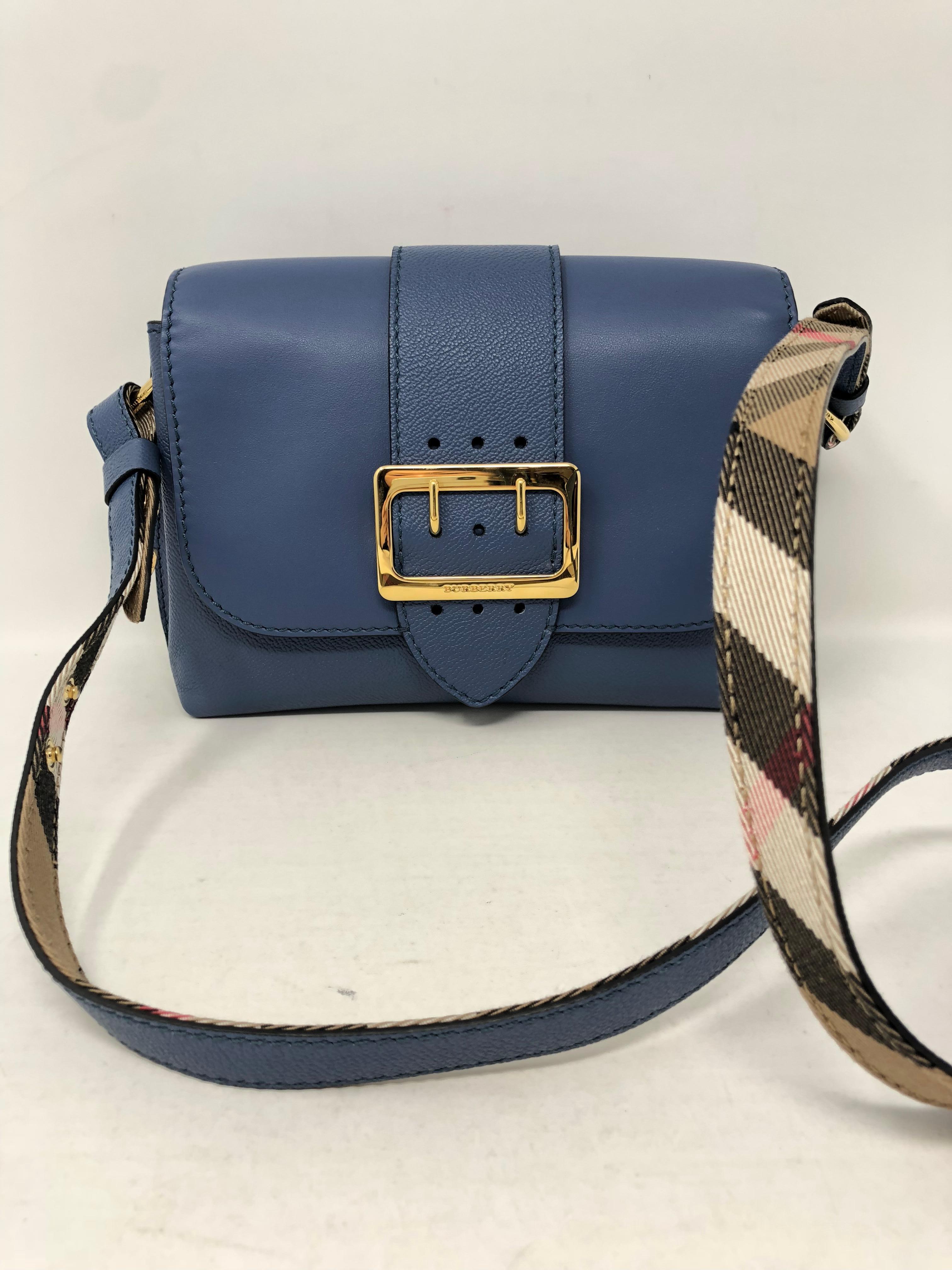 Burberry Crossbody bag with blue leather body. Classic tartan plaid strap and interior. Brand new and never used. Classic style. Guaranteed authentic. 