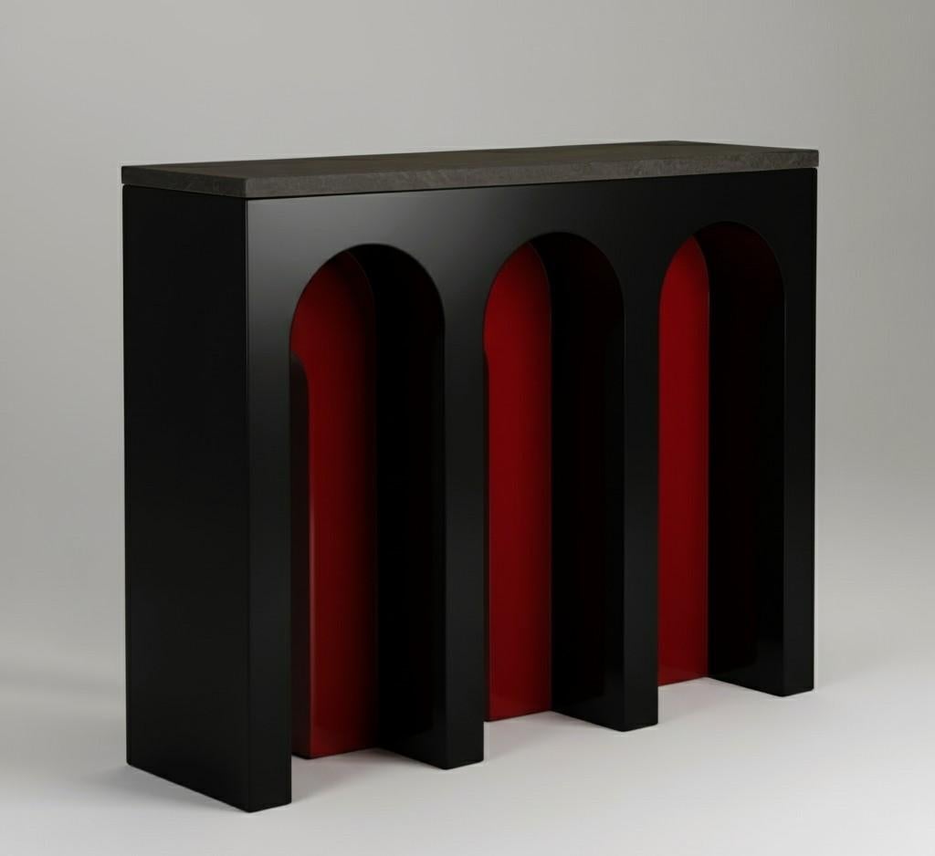 This console is made of oak wood with a limed finish and a top in noble pietra grey stone, which adds a touch of luxury and sophistication. It has a rectangular shape with archways cut out of the front panel. The archways add a touch of whimsy and