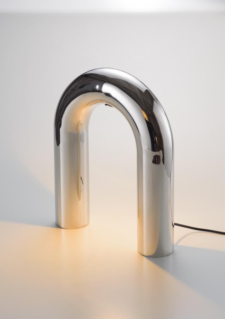 The Arco Lamps are made from a prolonged section of circle that stand out by the discontinuity of its shape. The collection consists of lamps that seem to penetrate the surfaces they touch, illuminating them delicately. The light focus frames the