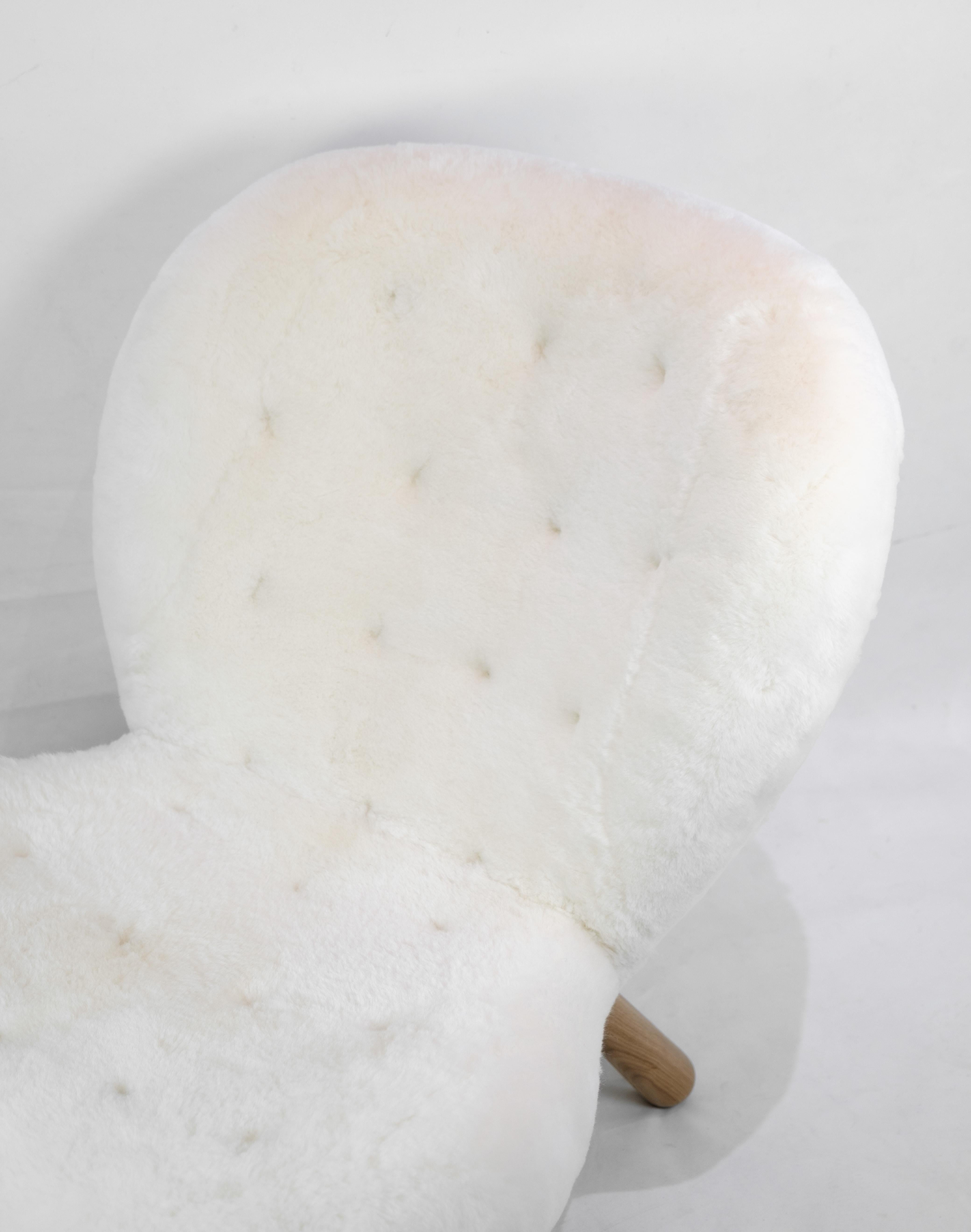 The Arctander chair, affectionately known as the (the Clam Chair), designed by Philip Arctander and upholstered with luxurious sheepskin. This lounge chair is renowned for its high quality and incredibly comfortable seat, making it the perfect