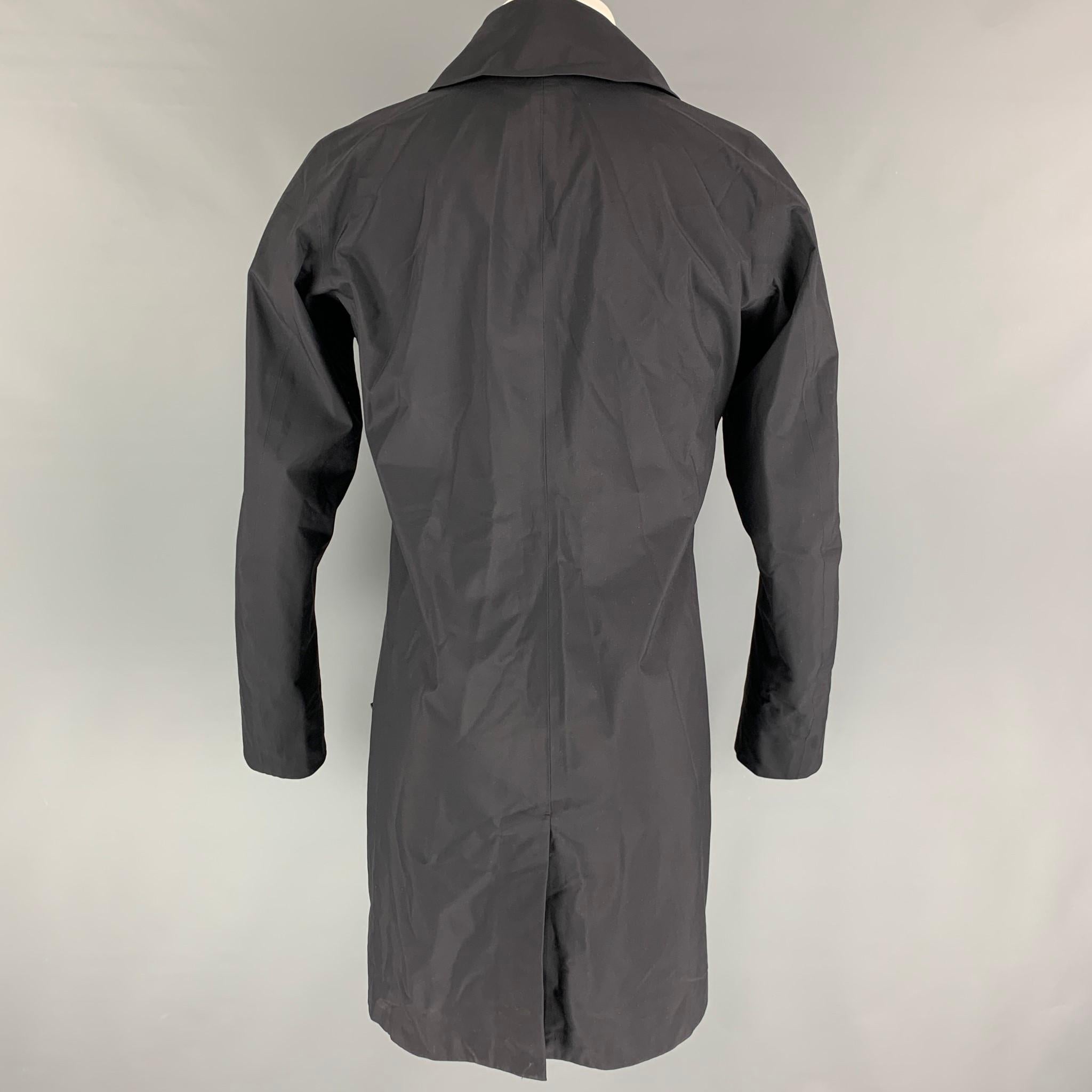 ARCTERYX 'VEILANCE' coat comes in a black nylon featuring a shawl collar, slit pockets, and a hidden snap button closure. 

Very Good Pre-Owned Condition.
Marked: S

Measurements:

Shoulder: 17.5 in.
Chest: 38 in.
Sleeve: 26.5 in.
Length: 37 in. 