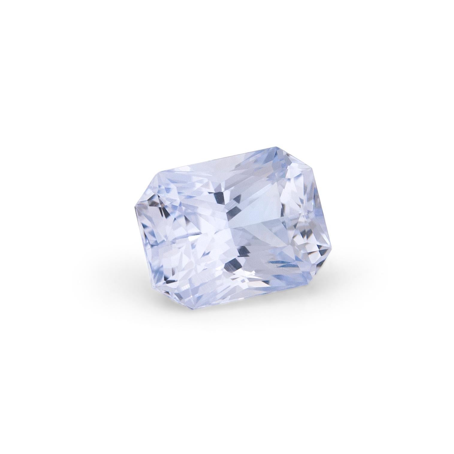 7.86ct natural colour Arctic Ice blue sapphire in octagonal/emerald cut with 2 tapered baguette diamonds on the side equal 0.57ct total. Side diamonds F/G colour VS clarity. Set in an 18k white gold ring. Size 6. Resizing up or down 2 sizes included