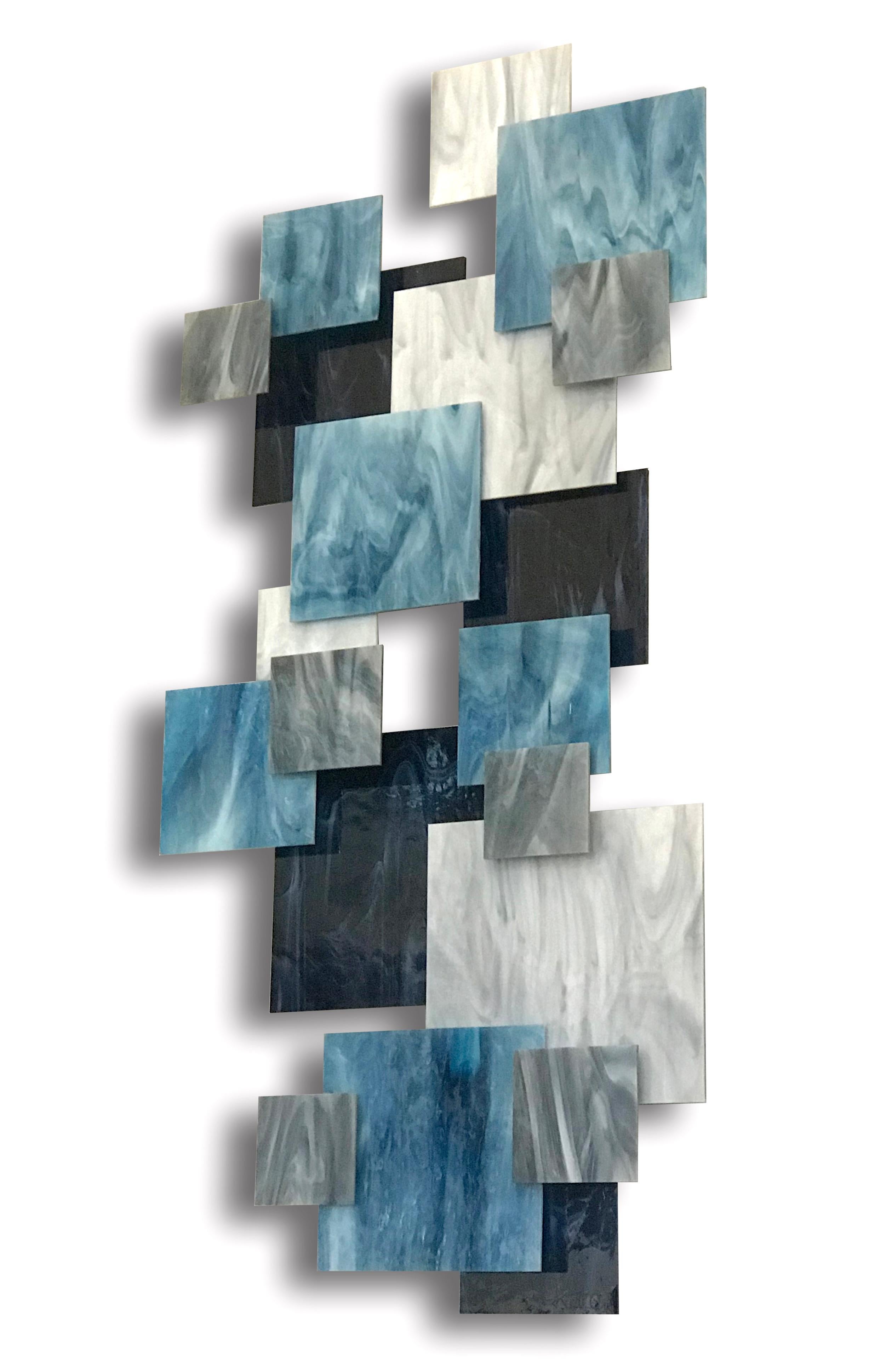 Individual pieces of glass are hand cut and placed over a welded metal frame on different elevations to create a 3D dynamic and harmonious composition. Each piece is hand created by the artist Karo Martirosyan in his studio in Los Angeles. With a