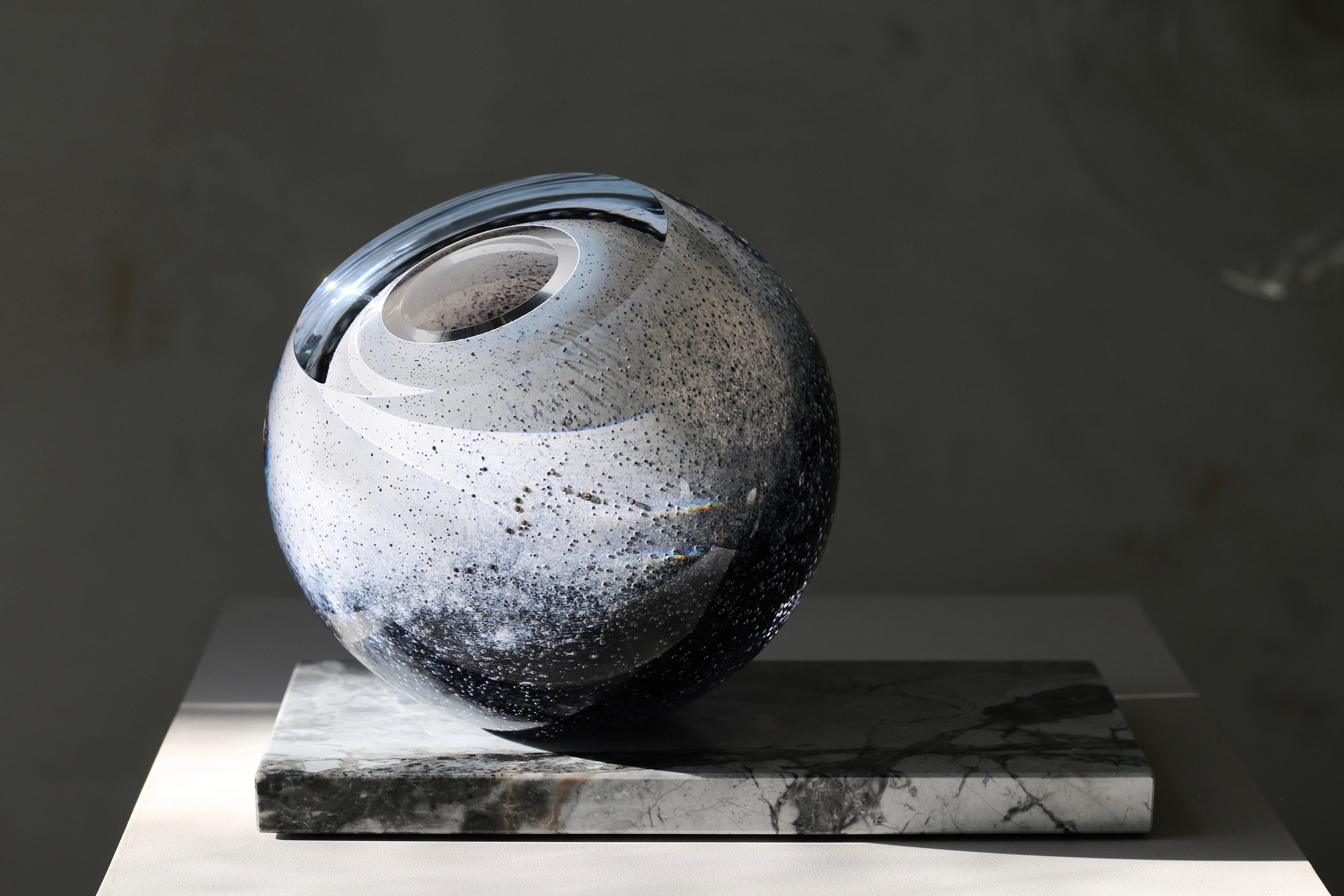 'Arctica' large sculptural vase from collection 'Mother Eternity' in mouth blown glass in dark blue and snow white on Côte d'Azur marble. 
It is composed of two details: glass sphere that is placed on a marble base. It sits in a round cut and can be