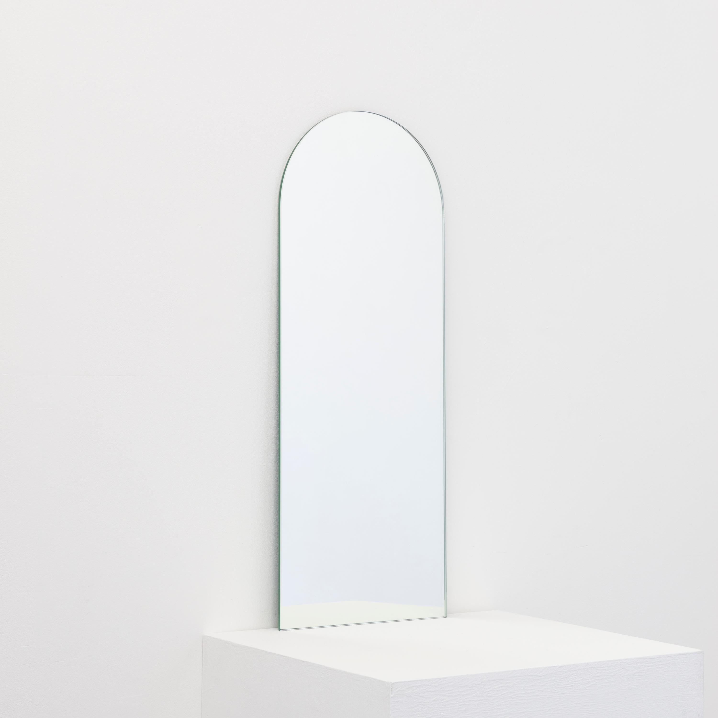Minimalist Arcus™ arch shaped frameless mirror with a floating effect. Quality design that ensures the mirror sits perfectly parallel to the wall. Designed and made in London, UK.

Fitted with professional plates not visible once installed for an