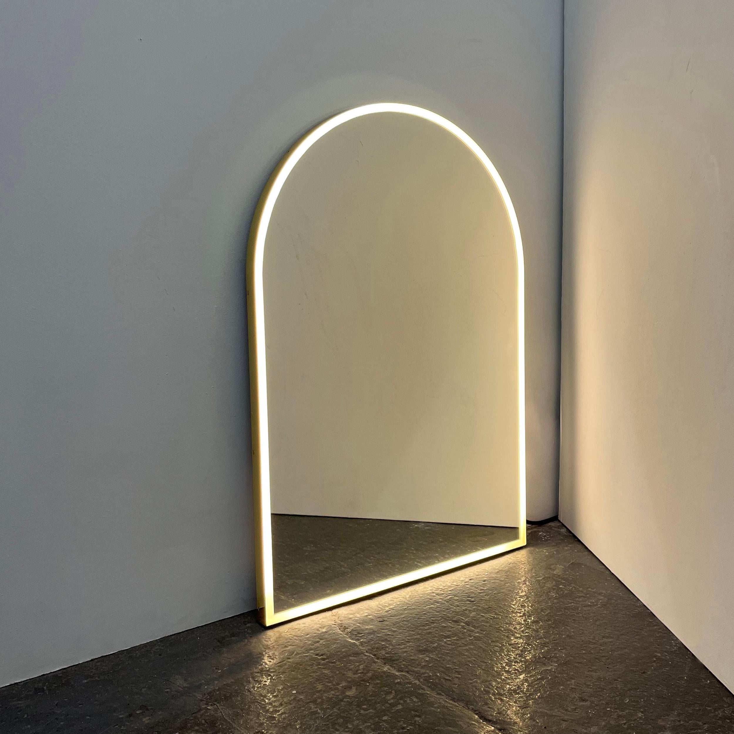 Contemporary handcrafted front illuminated large arched mirror with a polished brass frame. Designed and handcrafted in London, UK.

Medium, large and extra-large (37cm x 56cm, 46cm x 71cm and 48cm x 97cm) mirrors are fitted with an ingenious French