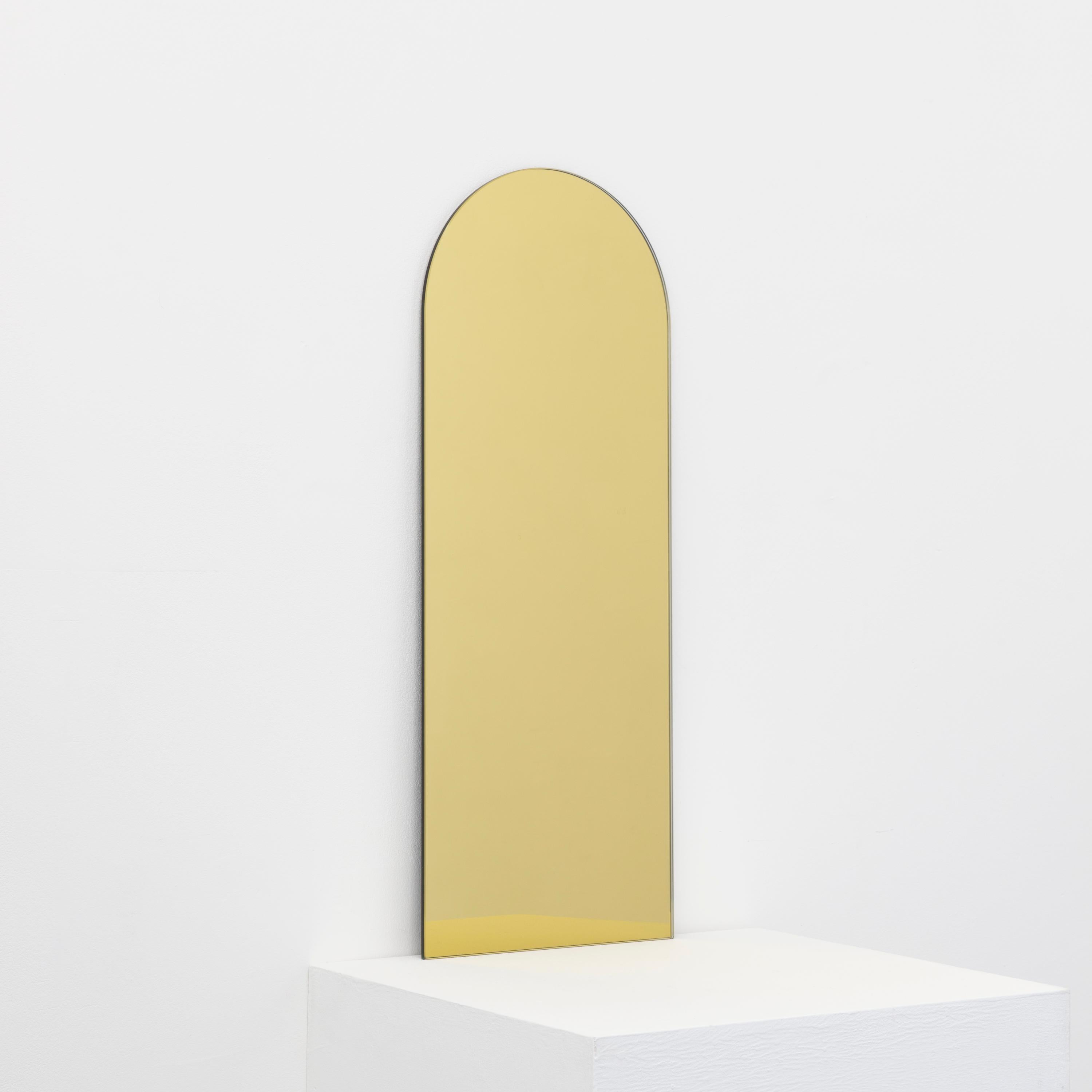 Minimalist Arcus™ arch shaped frameless gold tinted mirror with a floating effect. Quality design that ensures the mirror sits perfectly parallel to the wall. Designed and made in London, UK.

Fitted with professional plates not visible once