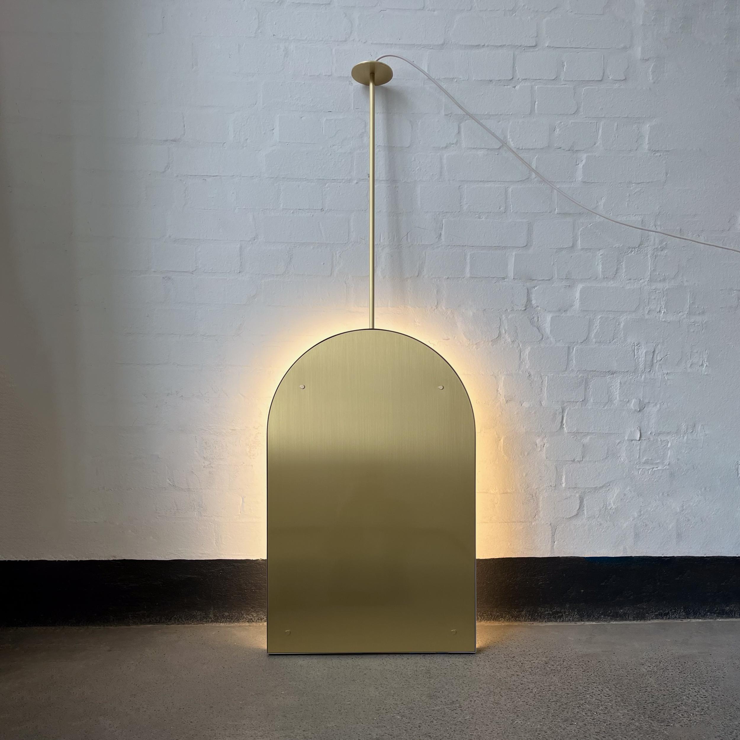 British Arcus Illuminated Ceiling Suspended Arched Contemporary Mirror with Brass Frame For Sale