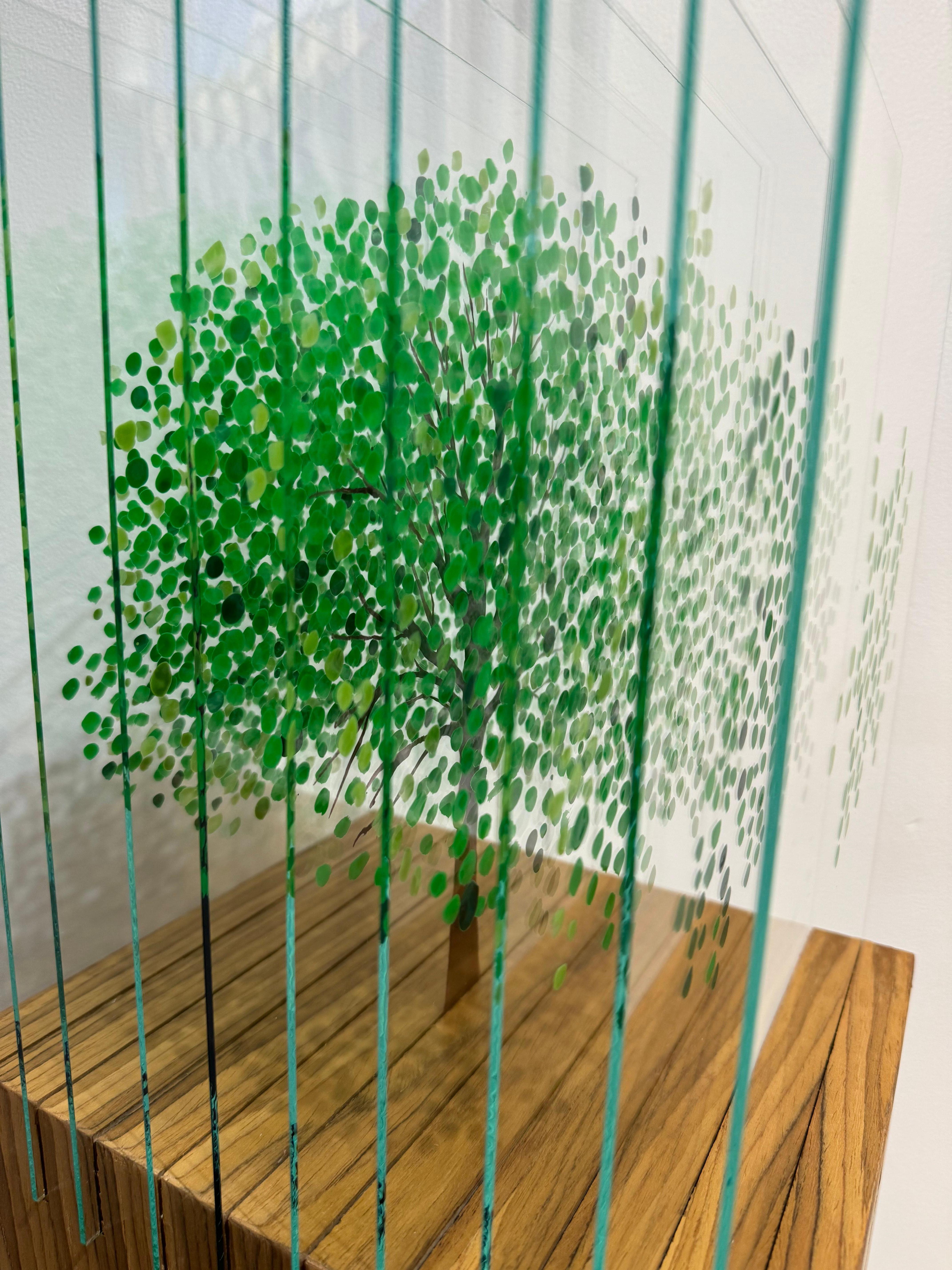 A sculpture made with glass layers and painted with nail polish and acrylic, set on an acrylic pedestal. 
The glass leaves are separated by slits on the pedestal and give the sculpture an extraordinary three-dimensional volume.

With the distinctive