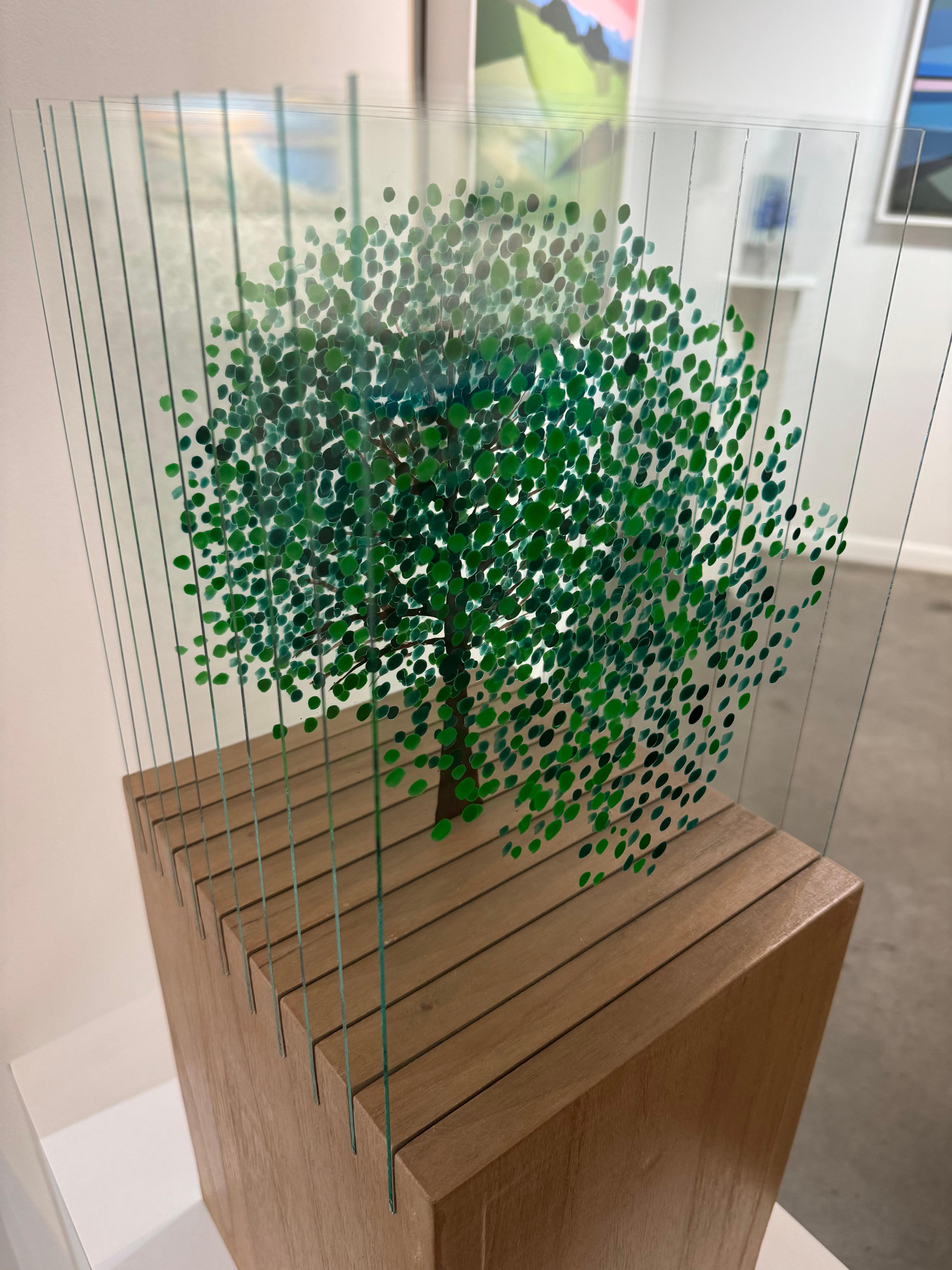 A sculpture made with glass layers and painted with nail polish and acrylic, set on an acrylic pedestal. 
The glass leaves are separated by slits on the pedestal and give the sculpture an extraordinary three-dimensional volume.

With the distinctive
