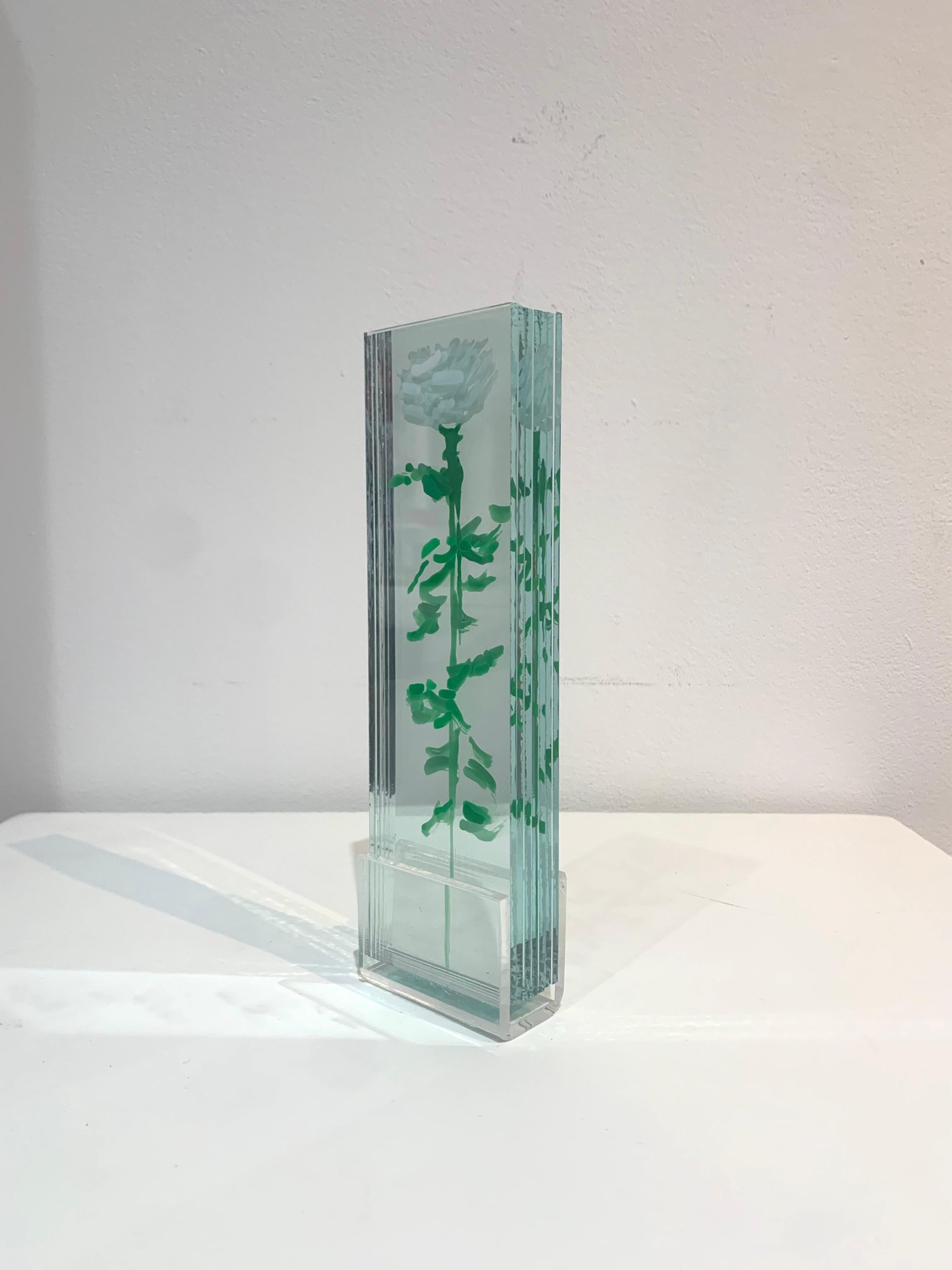 A sculpture made with glass layers and painted with nail polish and acrylic, set on an acrylic pedestal. 
The glass leaves are separated by slits on the pedestal and give the sculpture an extraordinary three-dimensional volume.

With the distinctive
