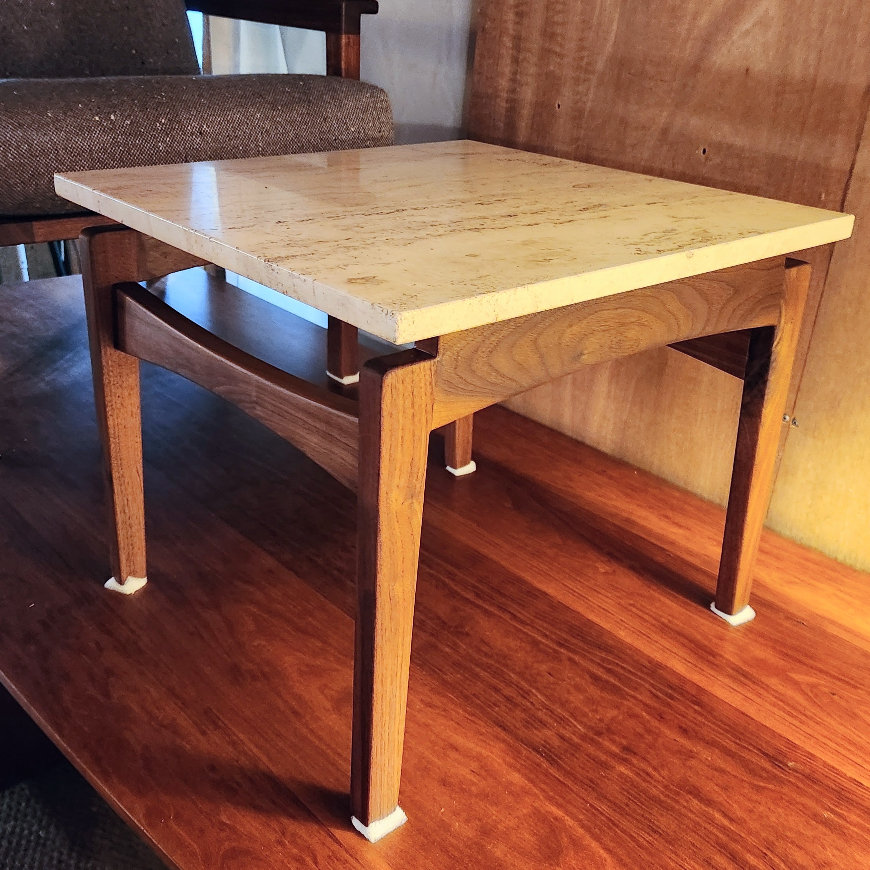 This classic side table was crafted from black walnut at the studio of  Arden Riddle in 1999. The design of this base and the use of a slightly off white travertine marble top is reminiscent of the work of Adrian Pearsall and Vladimir Kagan. 
The