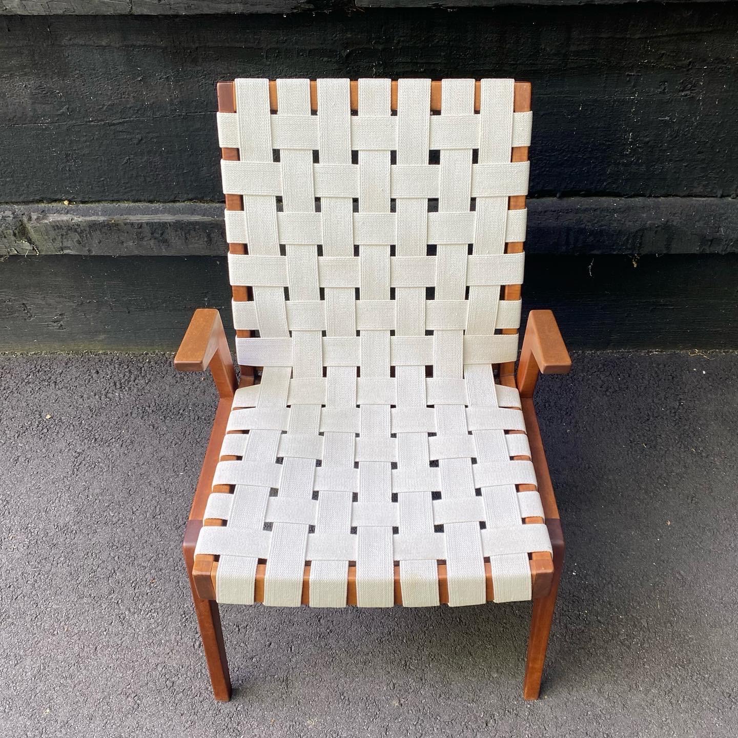 From the estate of Arden Riddle, this solid cherry wood lounge chair is covered in a thick white woven webbing, which was redone in the last 5 years. There are some light imperfections from age and use to the webbing, but overall it presents well.