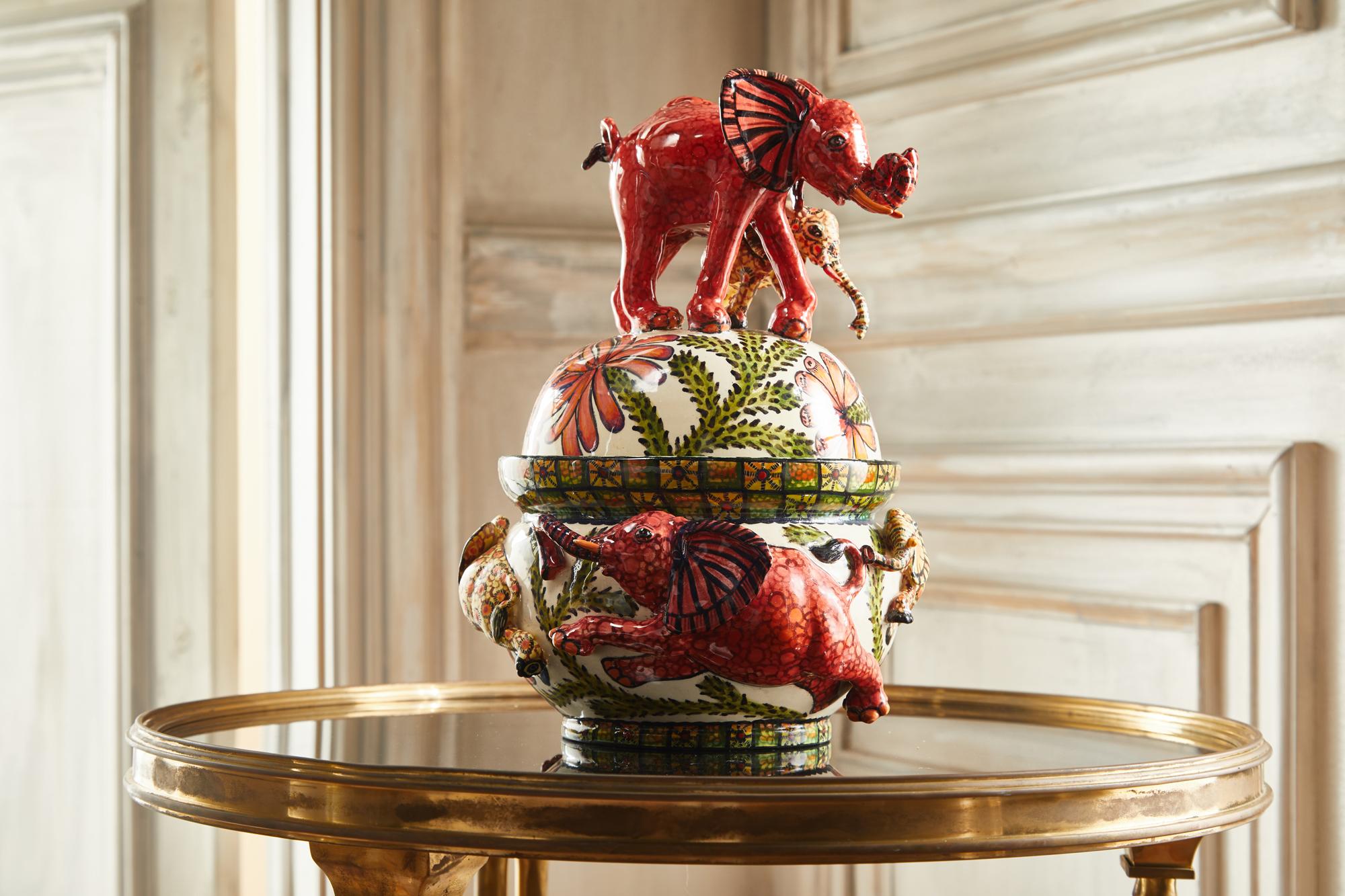 Fall madly in love with our Elephant Tureen, featuring a fantastic sculpture of red and yellow elephants. Its sumptuous exotic flora and refined details make it an exceptional piece worth grand interior design projects.

The mystical world of