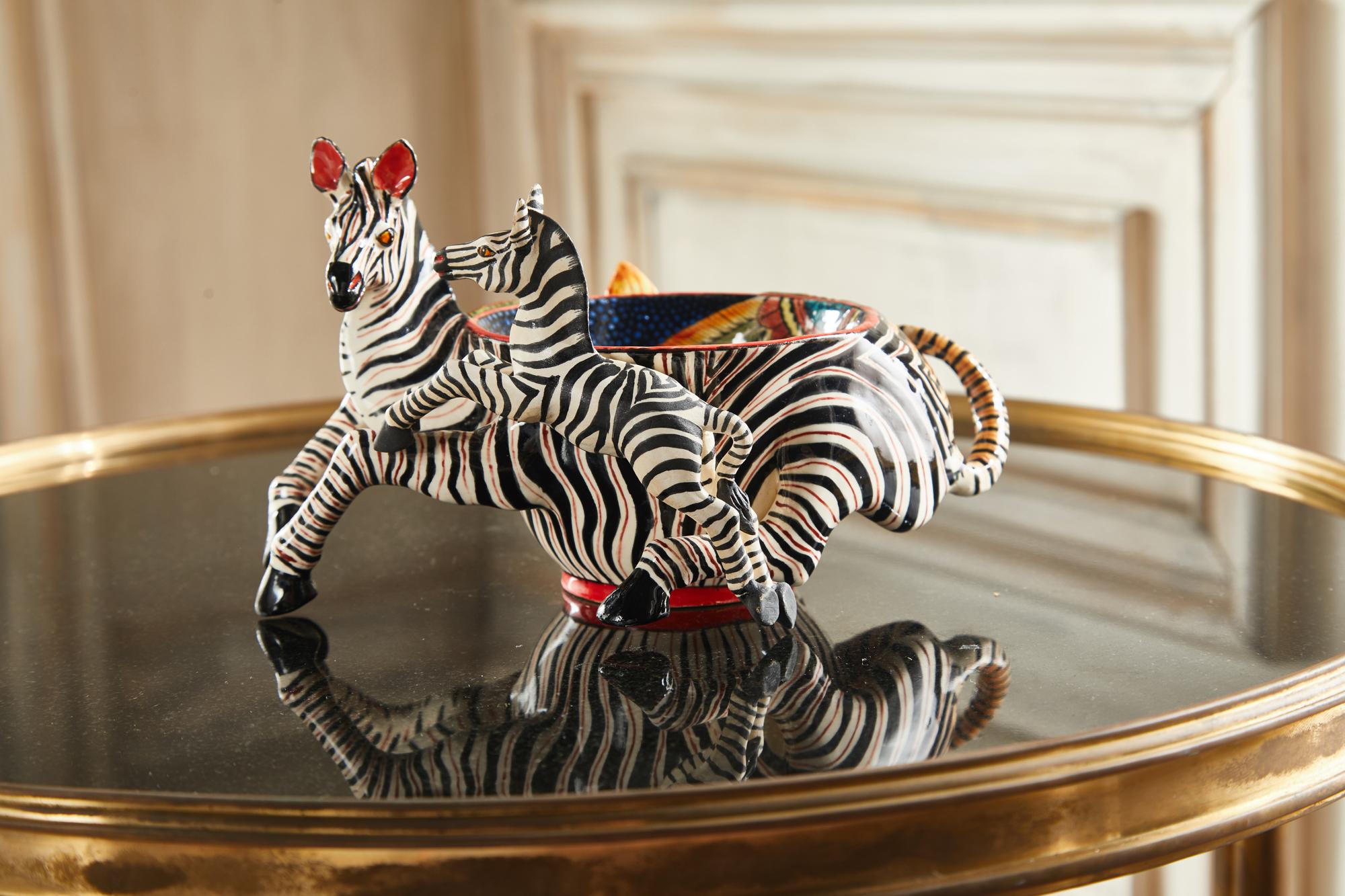 The black, white, and red Zebras are alluring to any perception of beauty. The somersaulting forms, red notes, and vibrant flower design create the authenticity of a timeless piece. A decorative bowl or tray piece perfect for any room.

The mystical