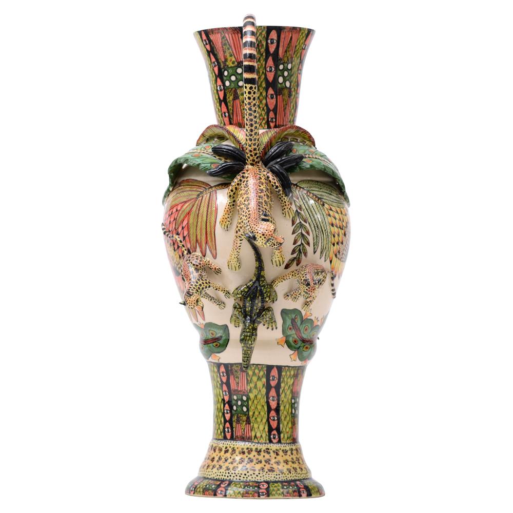 Introducing the Ardmore Ceramics Hand-Painted Ceramic Vase, a true masterpiece crafted in South Africa by the skilled hands of artists Punch Shabalala and Thabo Mbhele. This remarkable vase stands at an impressive 20 inches high and is a testament
