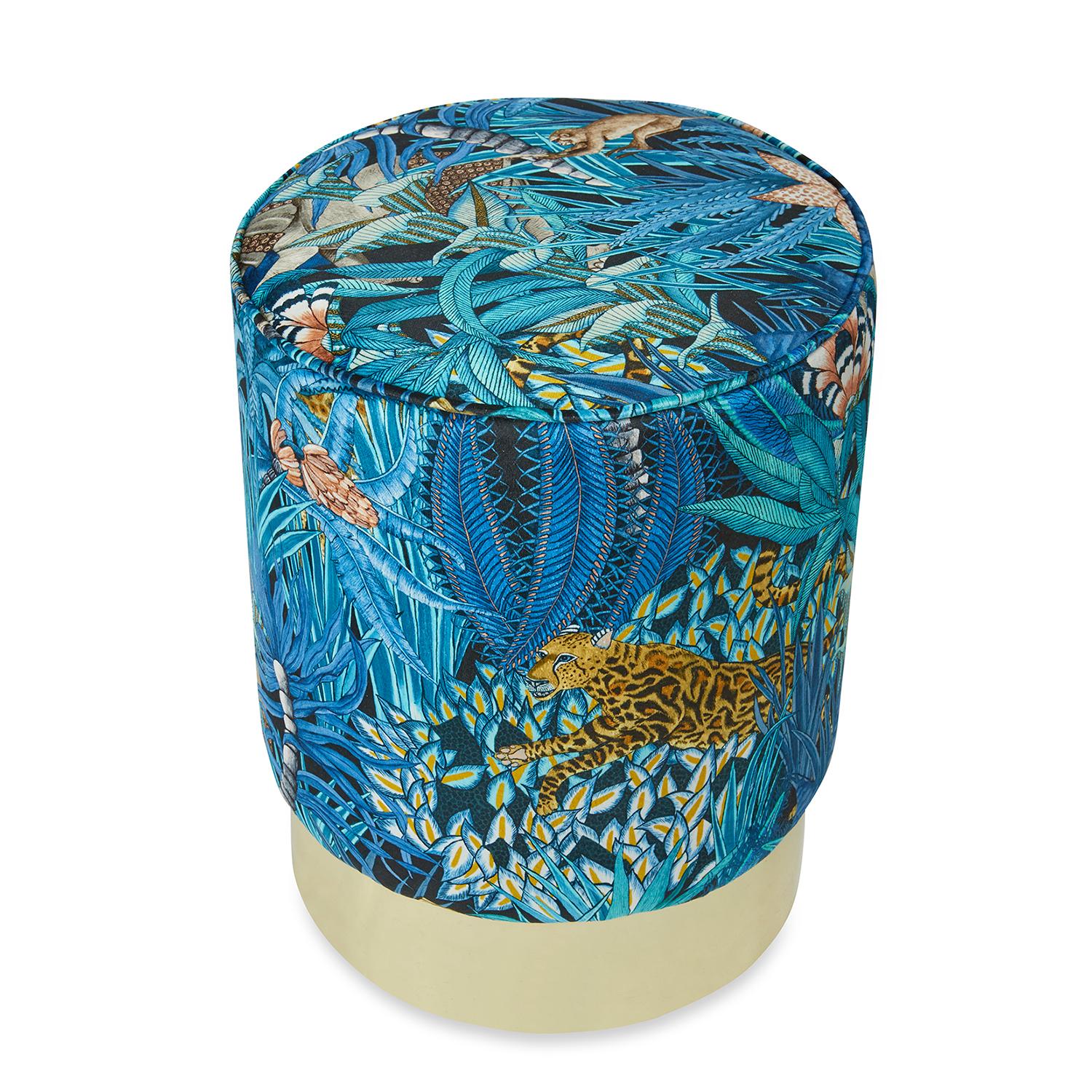 This ottoman's velvet upholstery, inspired by the fauna and flora of South Africa's Kruger National Park, sits atop a gleaming golden base. Ample high-density foam fill ensures long-lasting comfort whether you're using the pouf as a seat or a