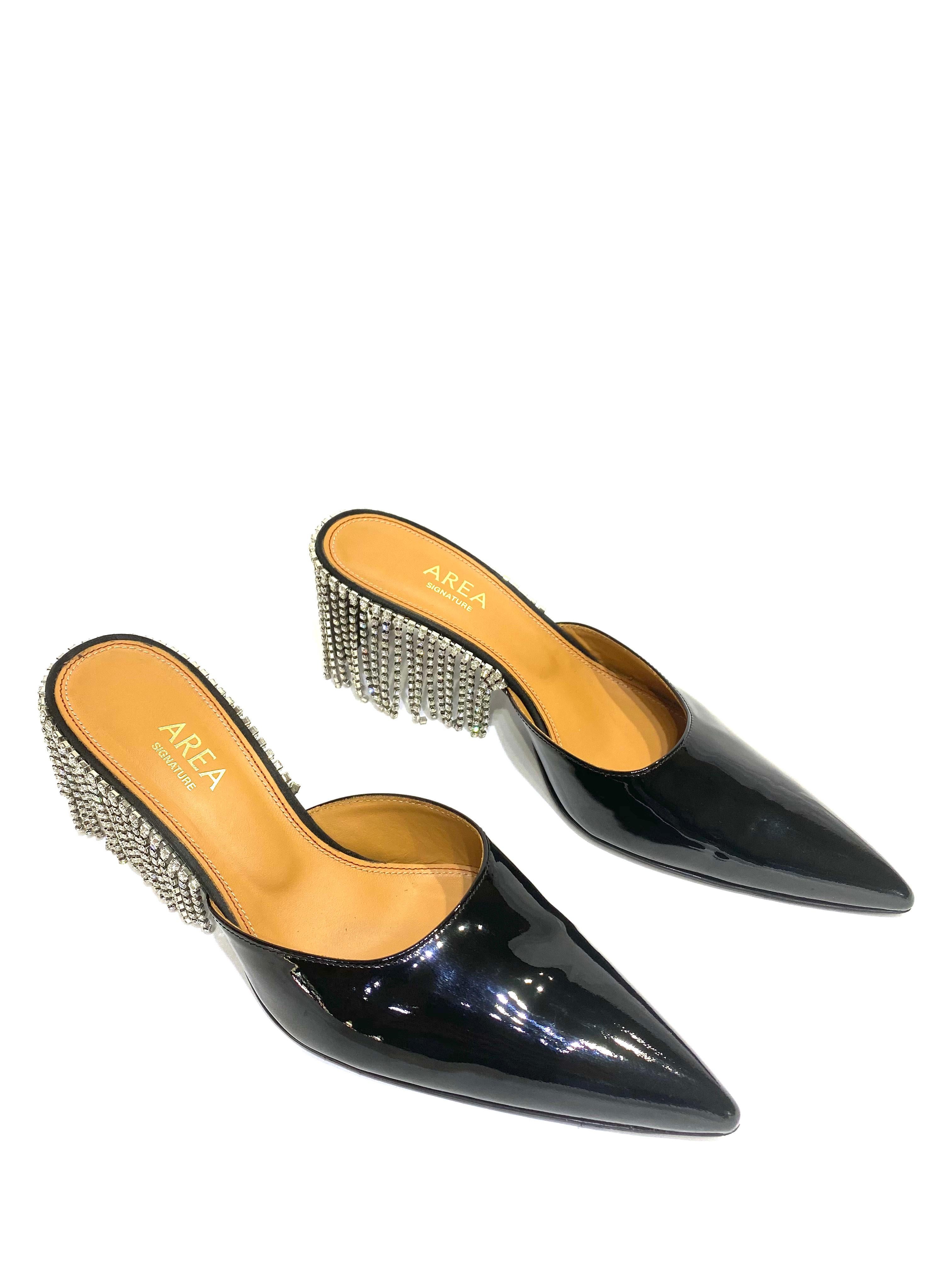 Product details:

Featuring black calfskin leather with patient finish, crystal fringe, pointed toe, kitten heel.
Made in Italy.