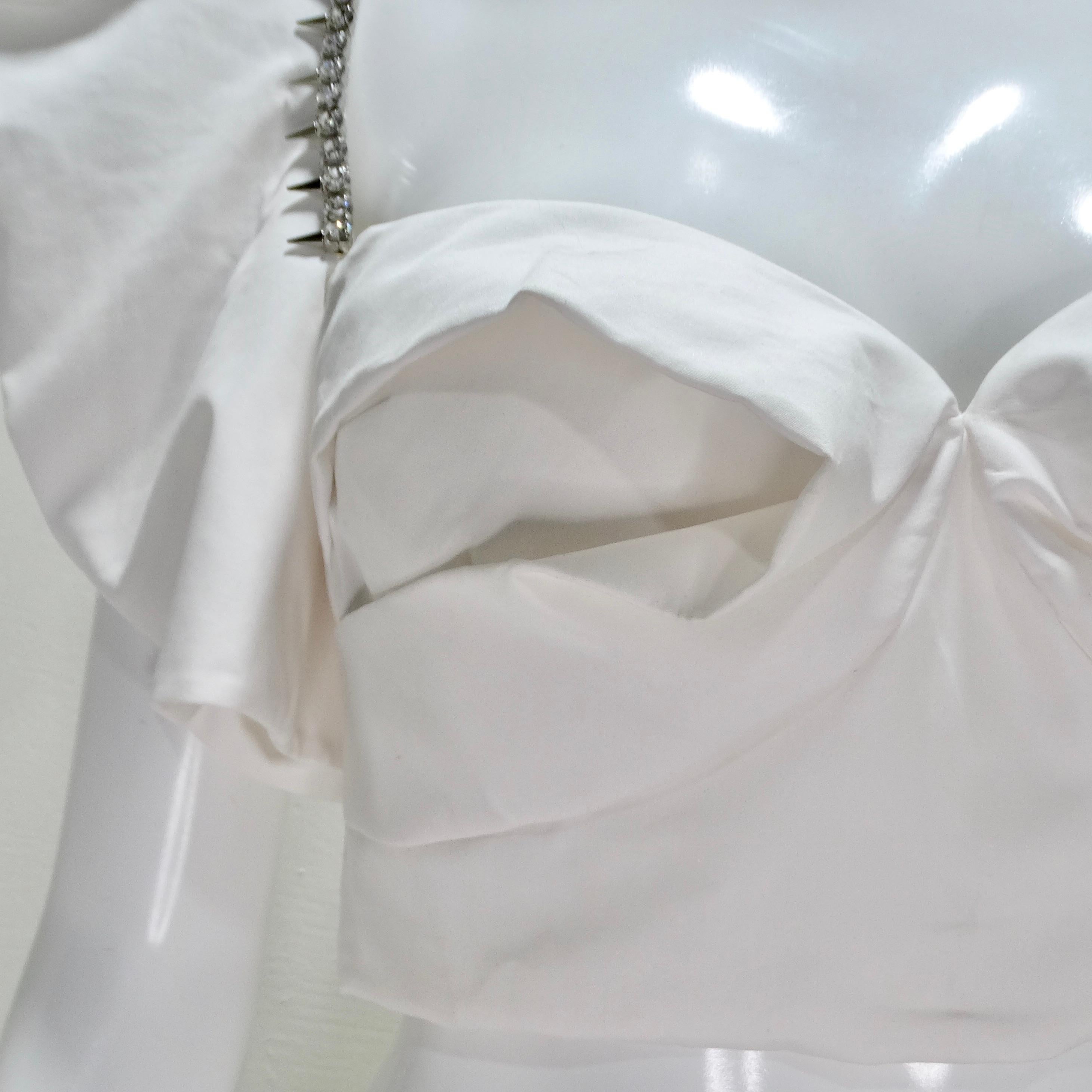 Dazzle in the spotlight with the Area Crystal-Trim Ruffle Crop Bustier Top, a show-stopping piece that blends bold style with elegant drama. This poplin-style white crop top is anything but ordinary, featuring dramatic flared sleeves and a