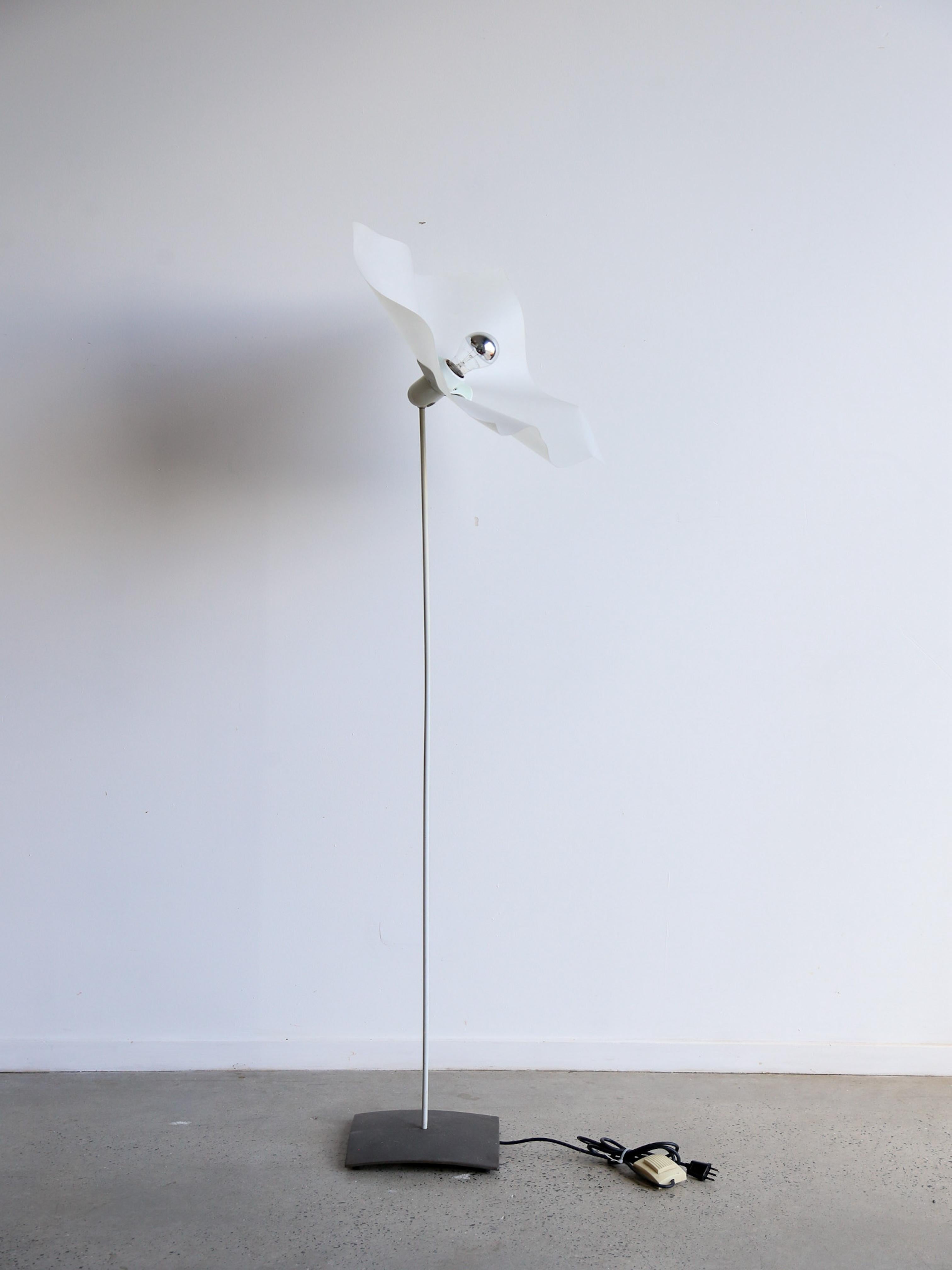 Mario Bellini, an Italian architect and designer, has made significant contributions to the design world, including collaborations with the various most prestigious worldwide brands. 

This floor lamp consist of a powder coated grey metal base, with