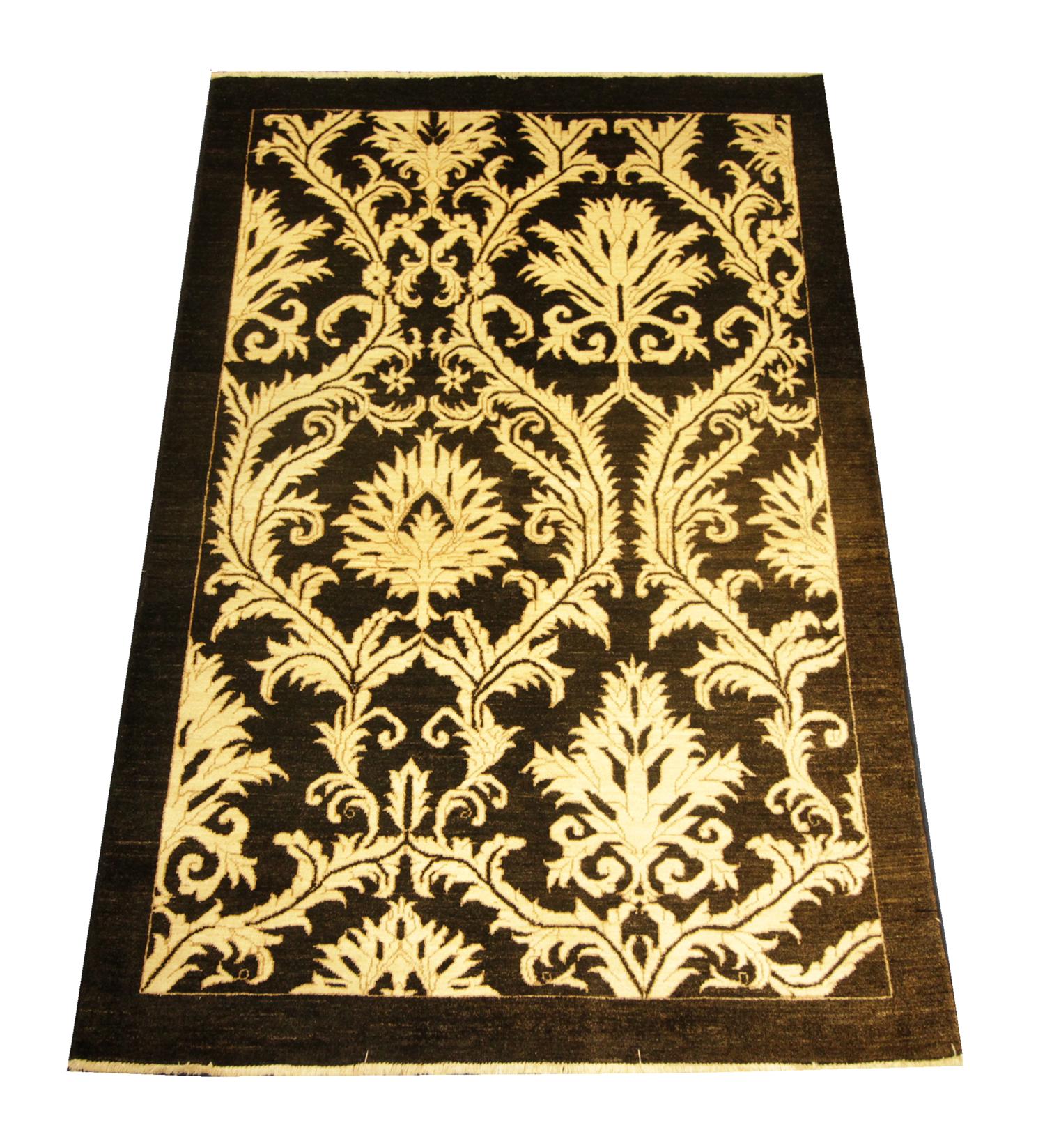 This fine wool Turkish rug was woven with the finest organic materials. The central design has been woven on a black background with an all-over floral pattern with a simple linear border woven in cream. The elegant design and sophisticated color