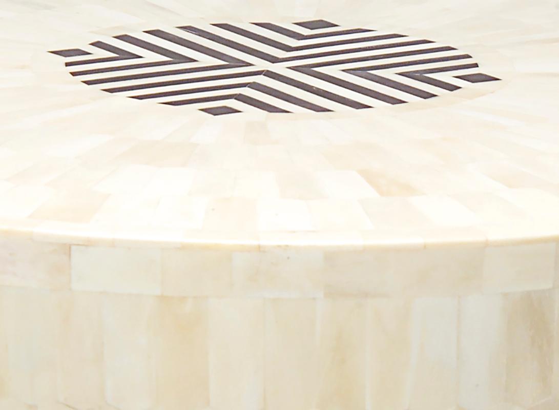 Made of wood and then tessellated with hundreds of sustainably sourced, hand carved hexagonal bone chips the Arena stool or end table flaunts a subtle tone-on-tone pattern. The top is decorated with contrasting inlay horn, which can be replaced a