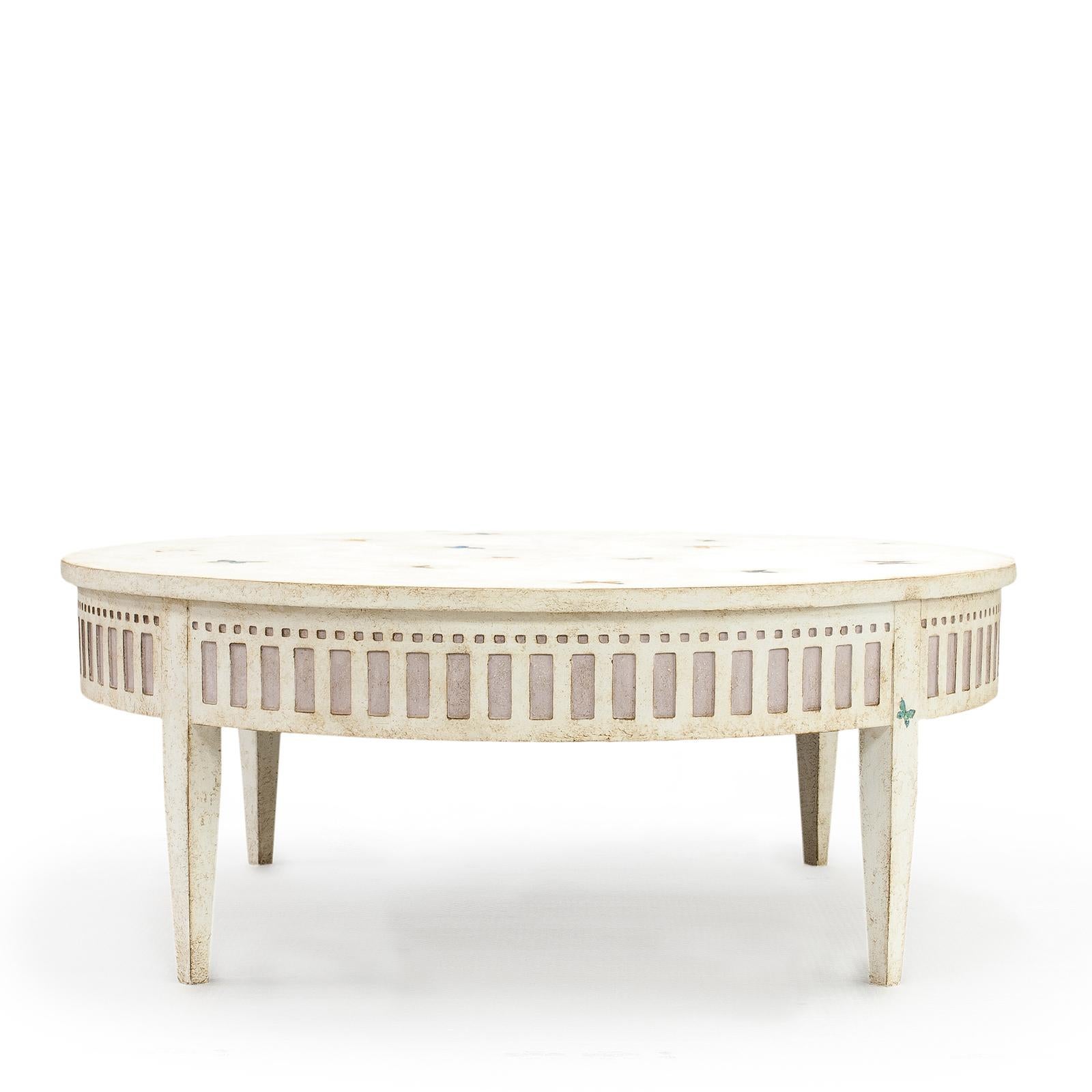 Inspired by the shape of the Verona Arena, a Roman amphitheater built in the first century renowned today for its large-scale opera performances, this stunning coffee table is hand painted in creamy white with an antique finish and colorful
