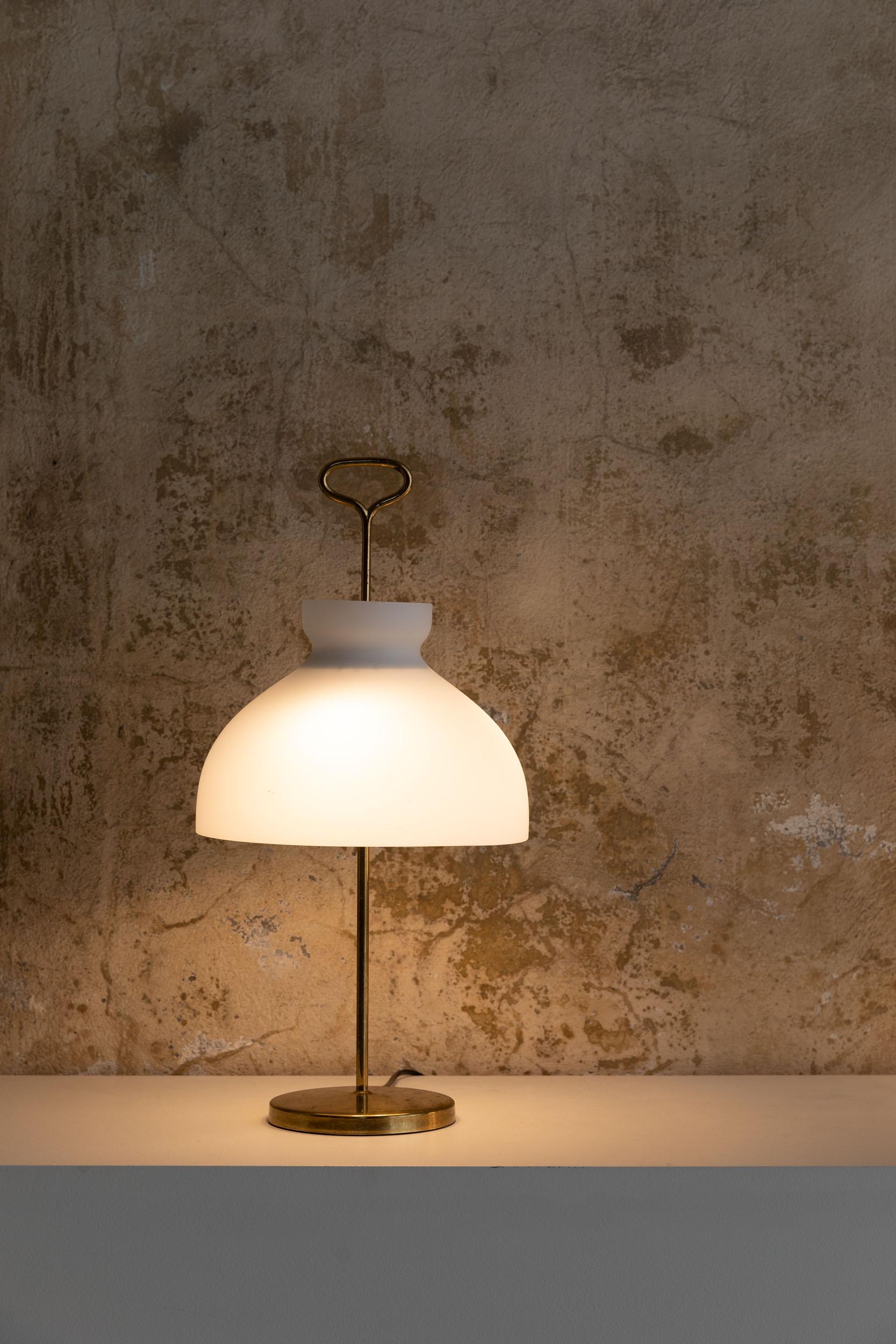 Stunning large Arenzano table lamp by Ignazio Gardella for Azucena, it can be coupled with the smaller Size table lamp you can see in the images. 
Opaline glass mounted on golden brass structure with beautiful original patina, Italy 1956.