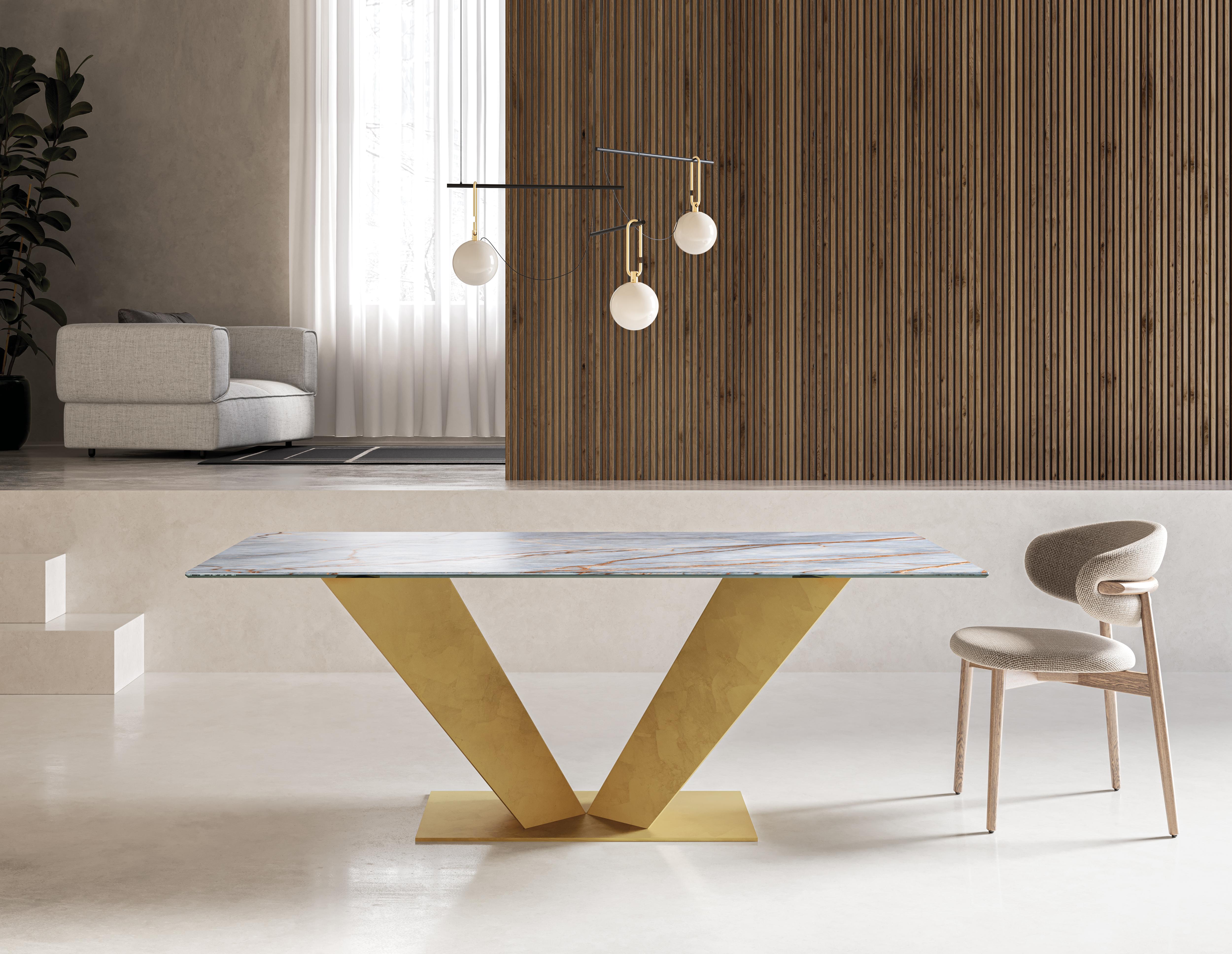 Ares Dining Table by Chinellato Design
Dimensions: W 250 x D 120 x H 72 cm
Materials: 
Top: Heritage Blue glossy Ceramic top and an Extra Clear Tempered Glass under-top.
Base: Large Piece Gold Leaf finish.


Ares, a rectangular dining table