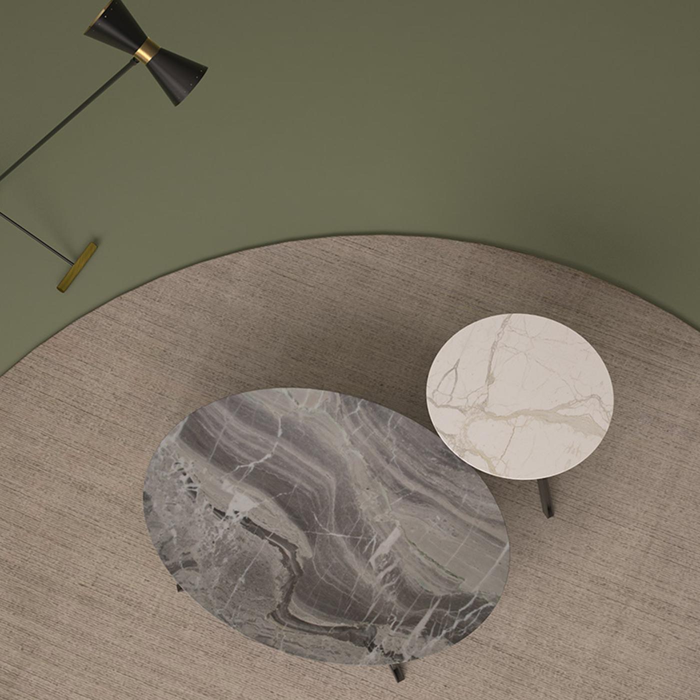 These two splendid coffee tables are supported by a base in steel and boast tops extracted in the Cornalita quarry in the village of Camerata Cornello in the Brembo Valley. The large one (82 x 120 x 30 cm) is in Orobico gray marble with a dark