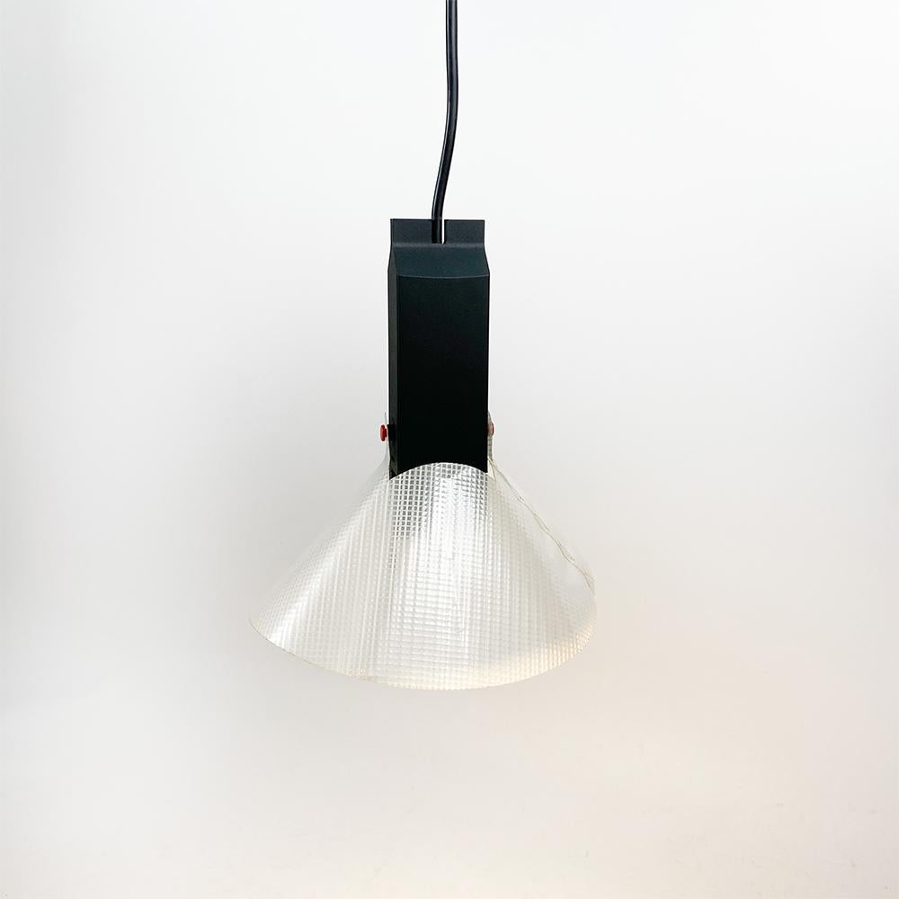 Aretusa ceiling lamp, design by Richard Sapper for Artemide, 1986.

Composed of a black plastic body with two small red pins to hang the diffuser. The plastic body houses the transformer and a socket for a 12v GU5.3 bulb. 

Original screen made