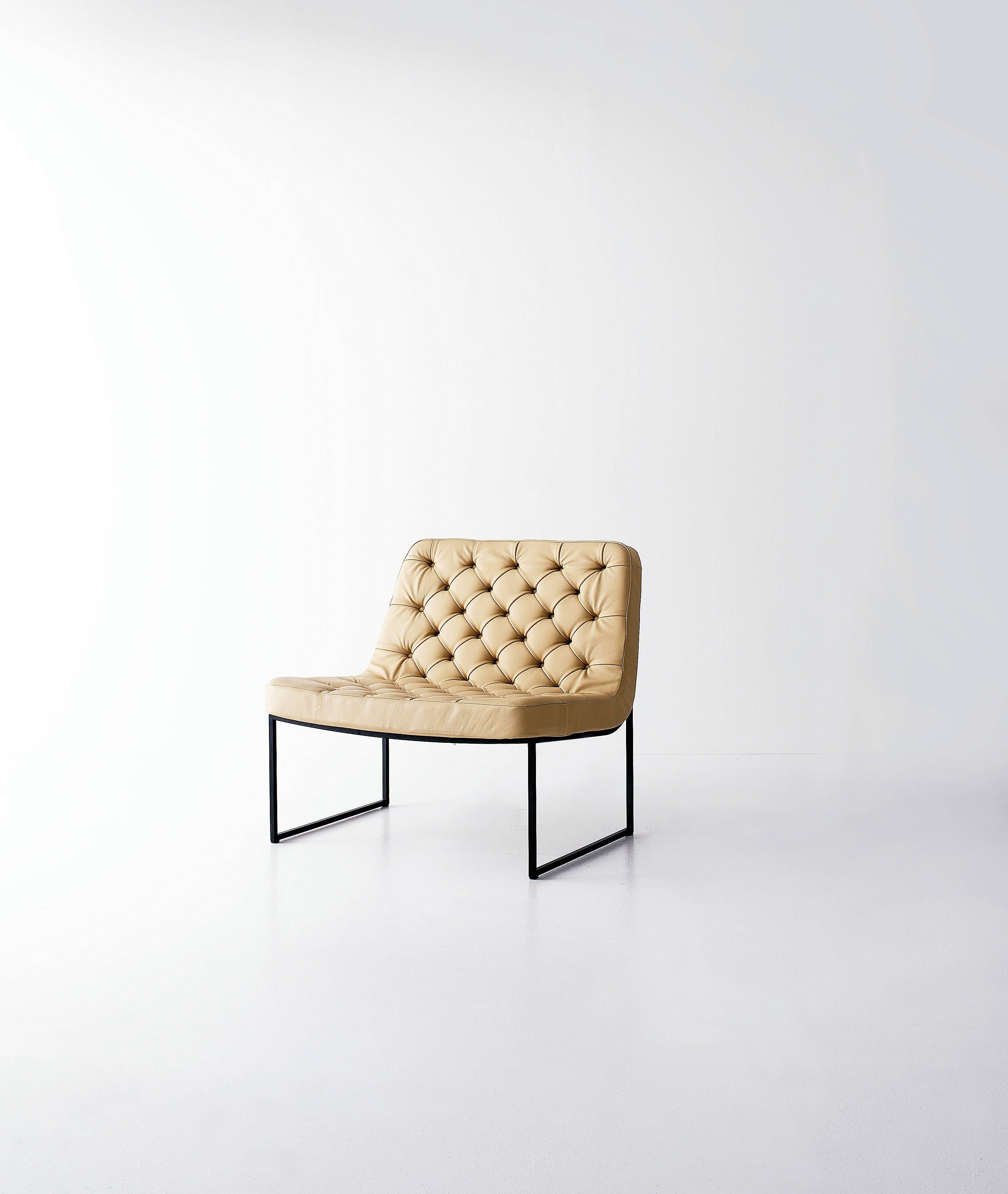 Small armchair with wide and comfortable seat, its look is made light through the frame in matt lacquered metal frame available in several colours. Available normal, quilted or with the elegant capitonné finish.

Pricing reflects chair upholstered