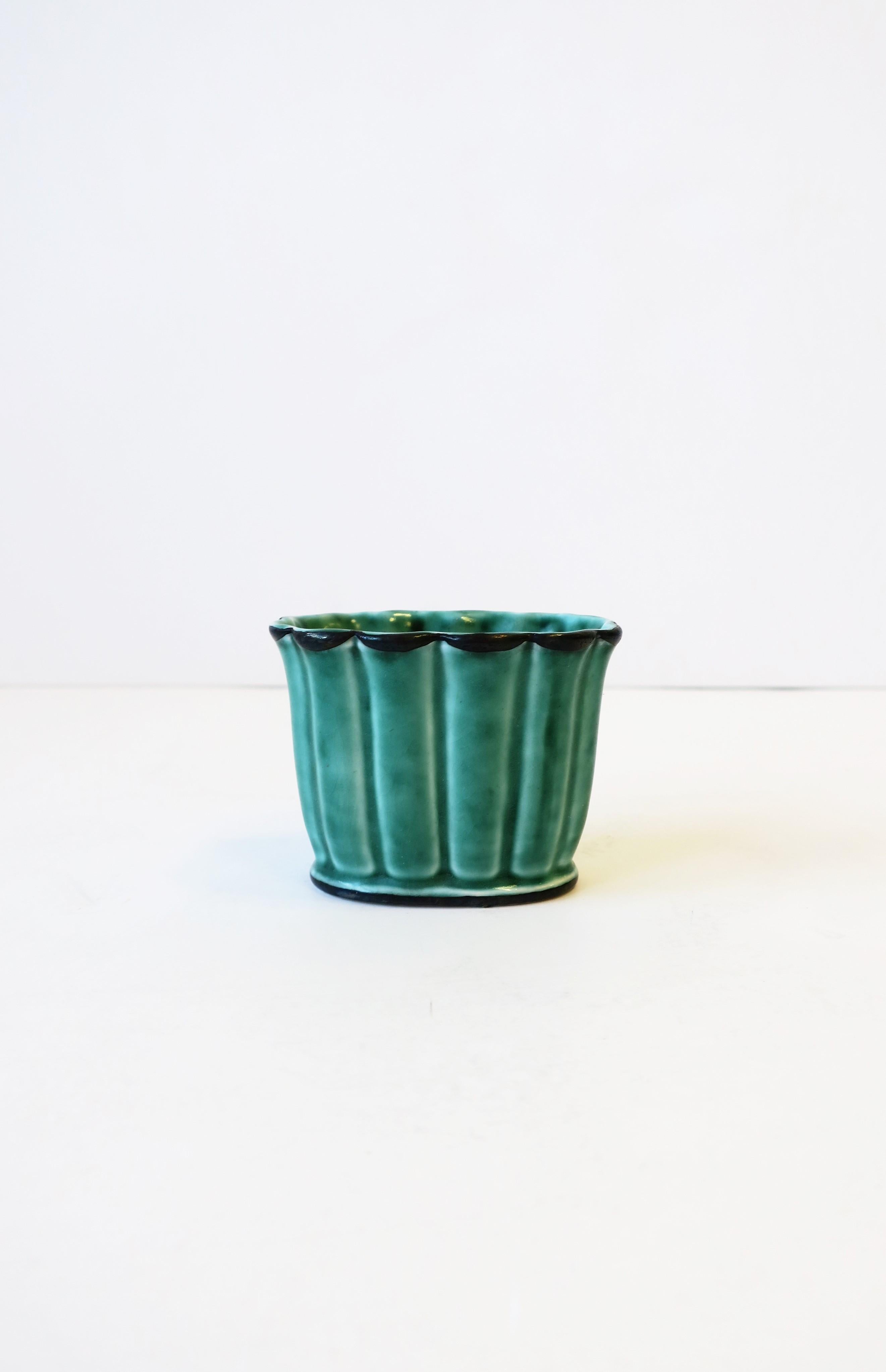 A beautiful petite Swedish pottery vessel by Wilhelm Kage for Gustavberg Argenta, in a green hue with decorative sterling silver leaf application, from Sweden. Piece is mid-20th century and was used to hold loose cigarettes'. Today, this piece can