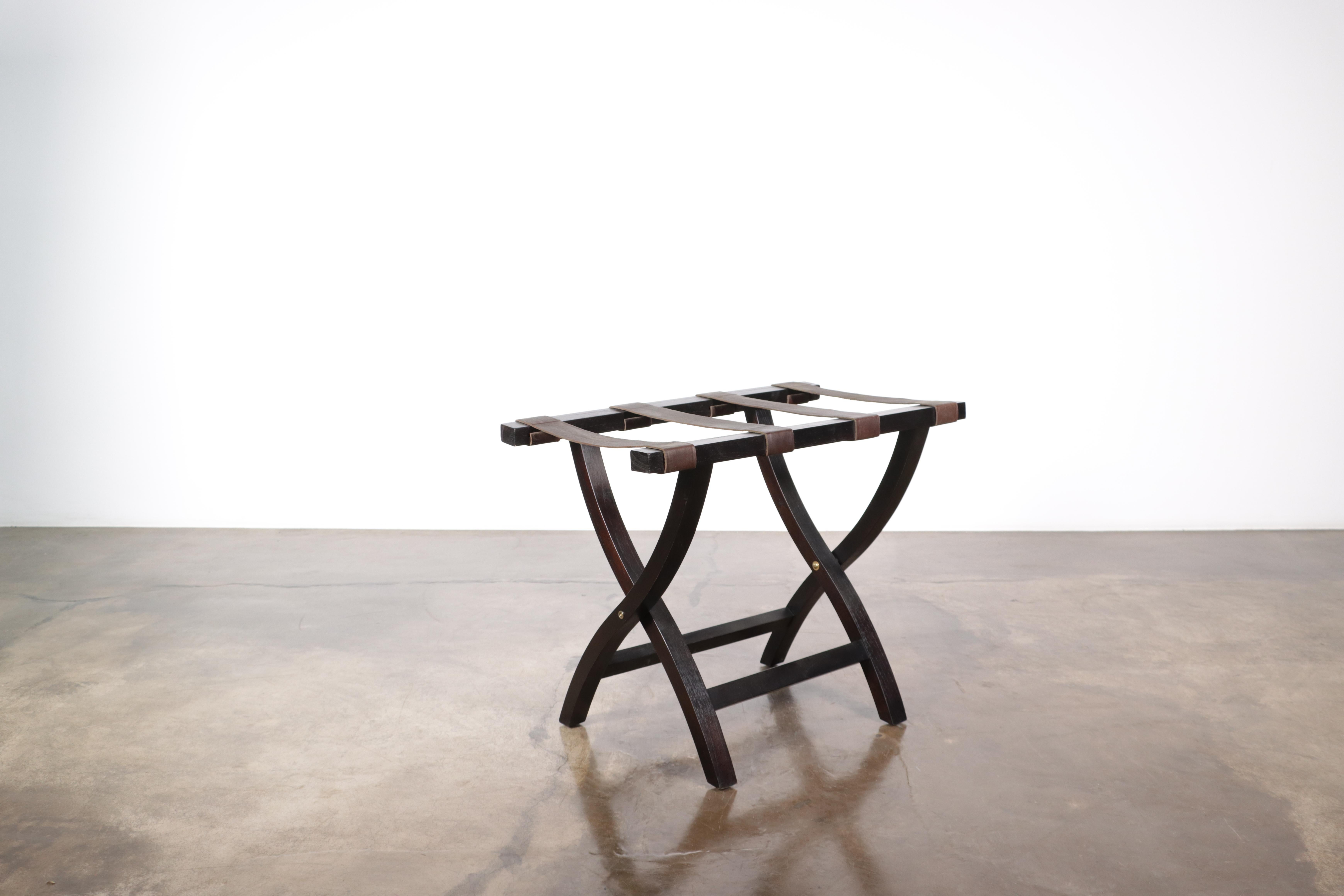 The Valerio Luggage rack features a solid Argentine Rosewood frame and a slung leather seat to support your luggage in style. Available in any finish or material for straps as well as custom sizing.

Measurements are: 26