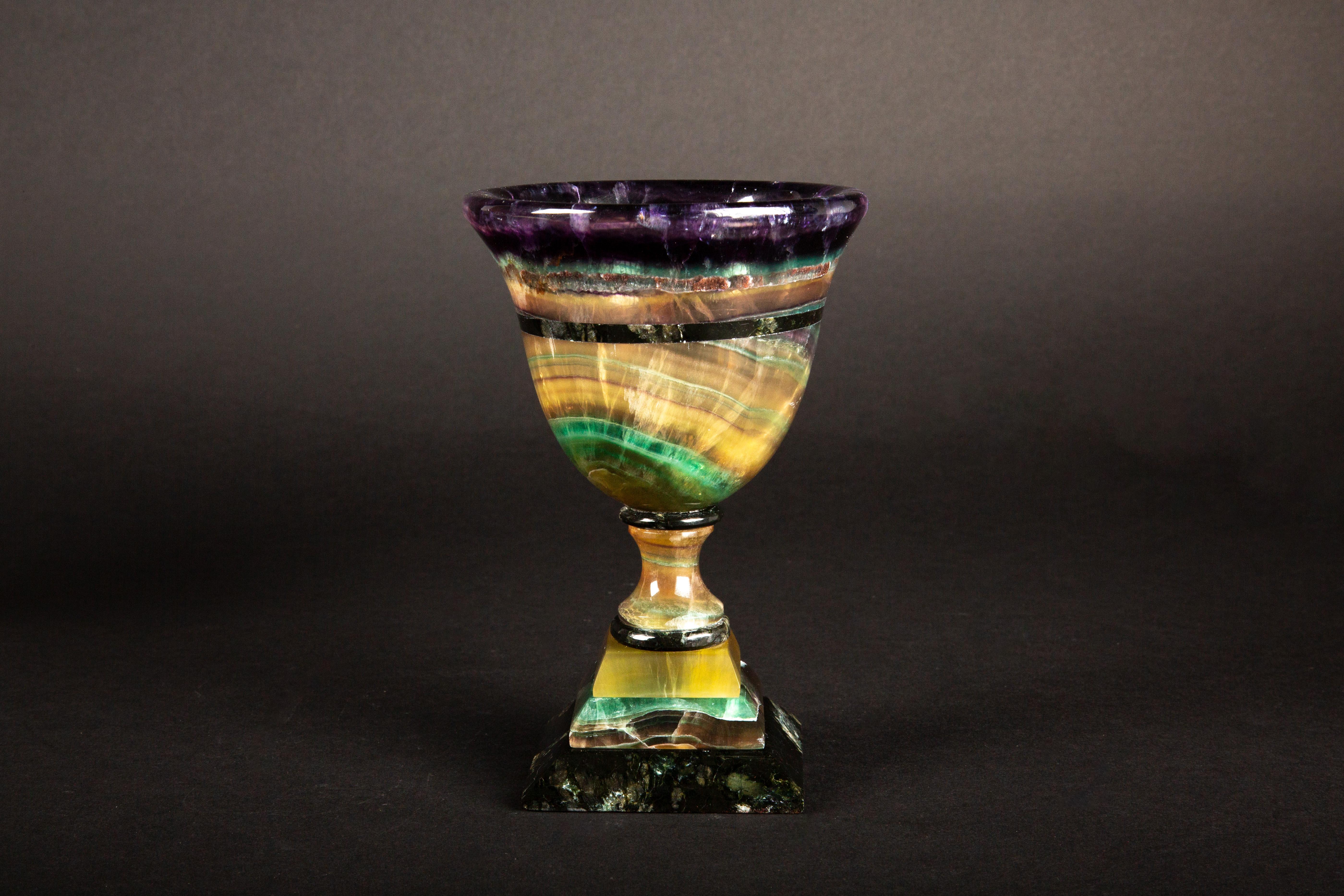 Crafted by skilled artisans in Argentina, this exquisite hand-carved chalice/cup showcases the captivating beauty of multi-colored fluorite. Originating from the depths of the earth, fluorite's unique hues swirl together in mesmerizing patterns,