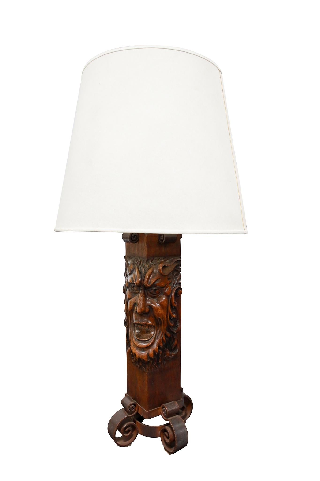 Argentinian Pair of Carved Oak & Iron Table Lamps. Wonderful carving of north wind face and decorative iron legs. Circa 1930.

Dimensions: 38 1/2