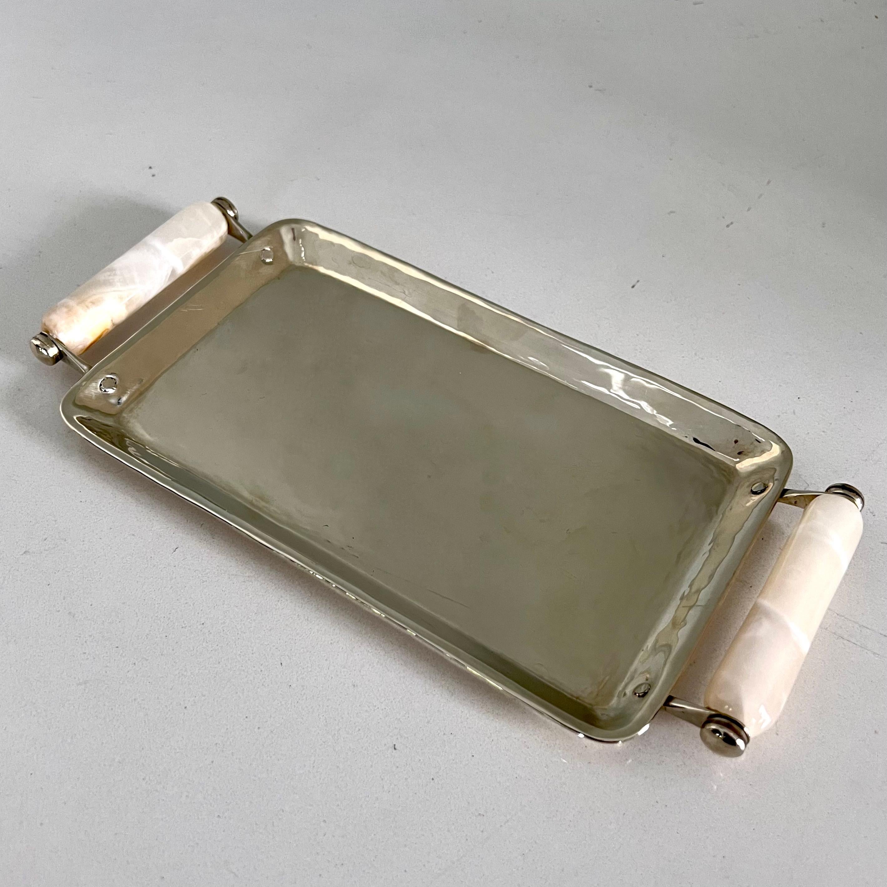 Silver plate tray with Onyx handles from Argentina. A compliment to any vanity or side table. Great for serving cocktails. Polished and ready to be used. 

See video for exquisite details.