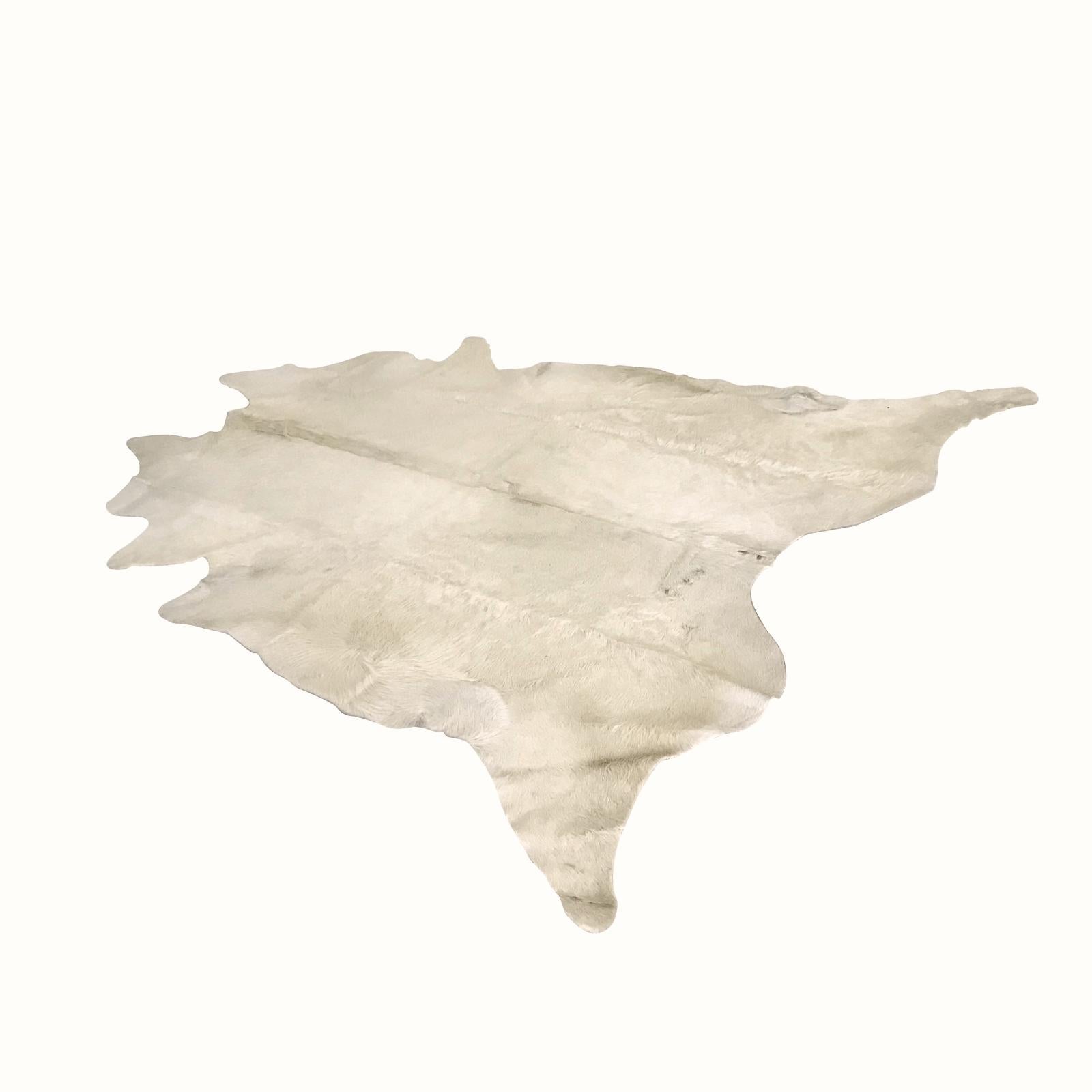 Contemporary white patchwork cowhide area rug from Argentina.
Makes a good throw rug.