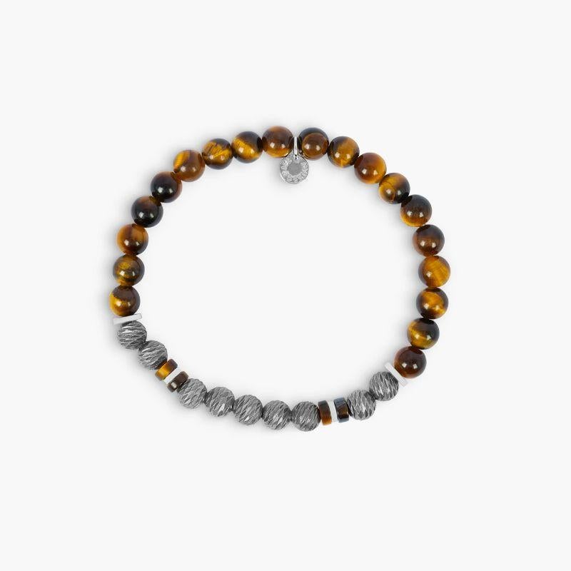 Argento Graffiato Bracelet with Tiger Eye in Rhodium-Plated Sterling Silver, Size L

Our latest take on the classic bead bracelet, this style consists of textured silver beads offset with black agate round beads and discs. Each bracelet has a